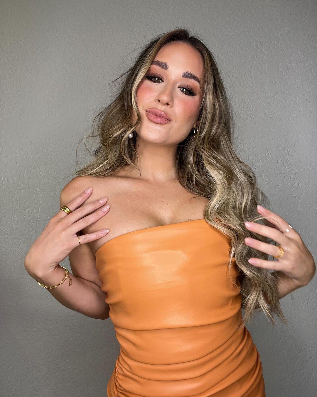 Rachel Recchia in orange dress