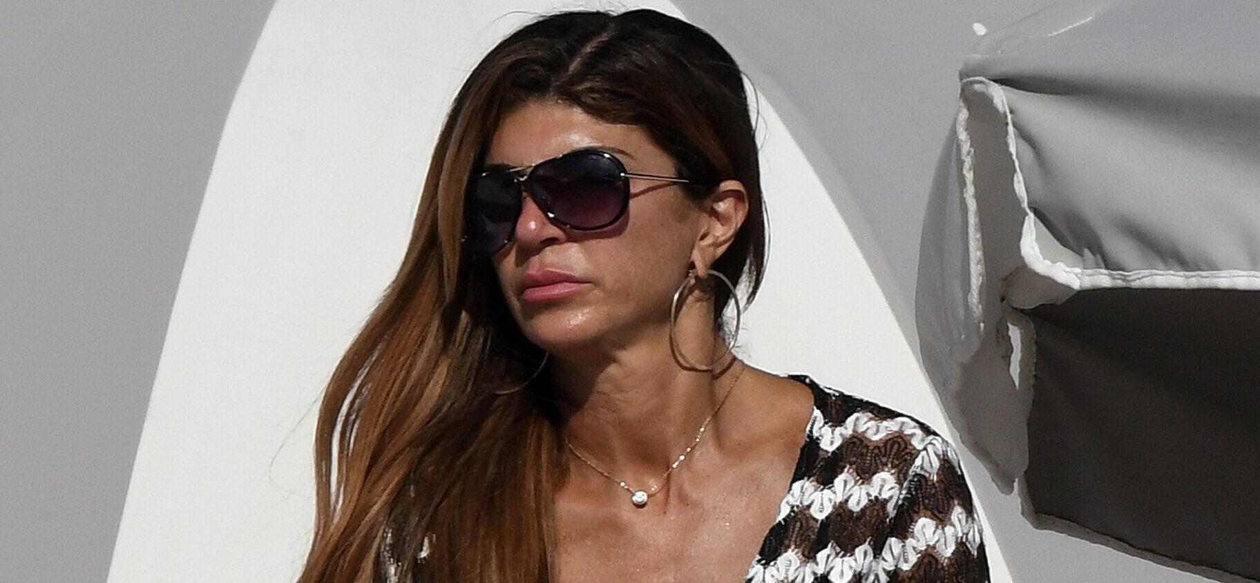 Teresa Giudice today linked to a handsome young toy boy wears a revealing crochet swimsuit on the beach in Miami