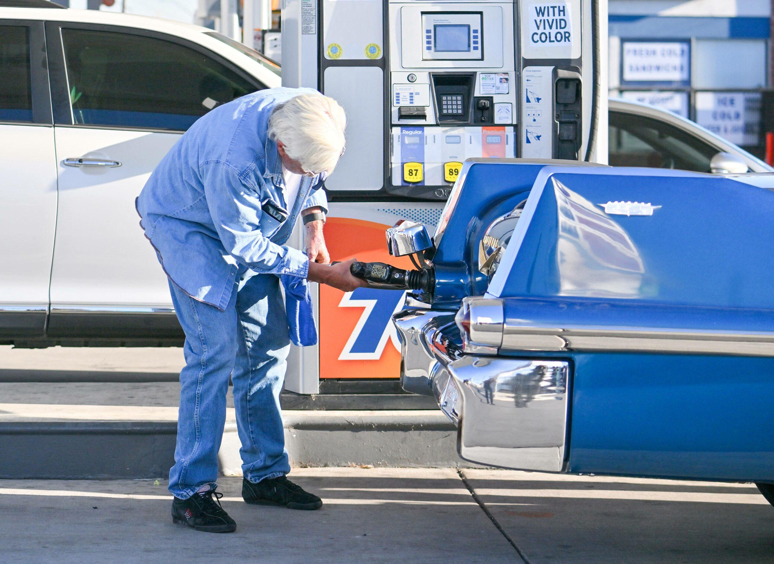 Jay Leno stops by a gas station in yet another cool car after getting out of the hospital yesterday