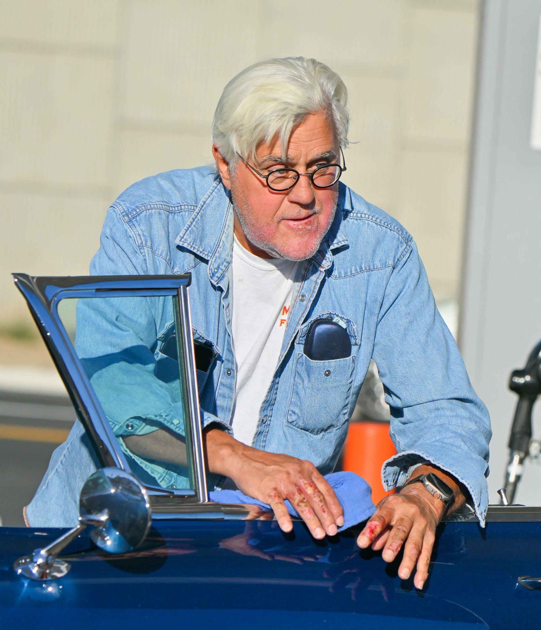 Jay Leno stops by a gas station in yet another cool car after getting out of the hospital yesterday