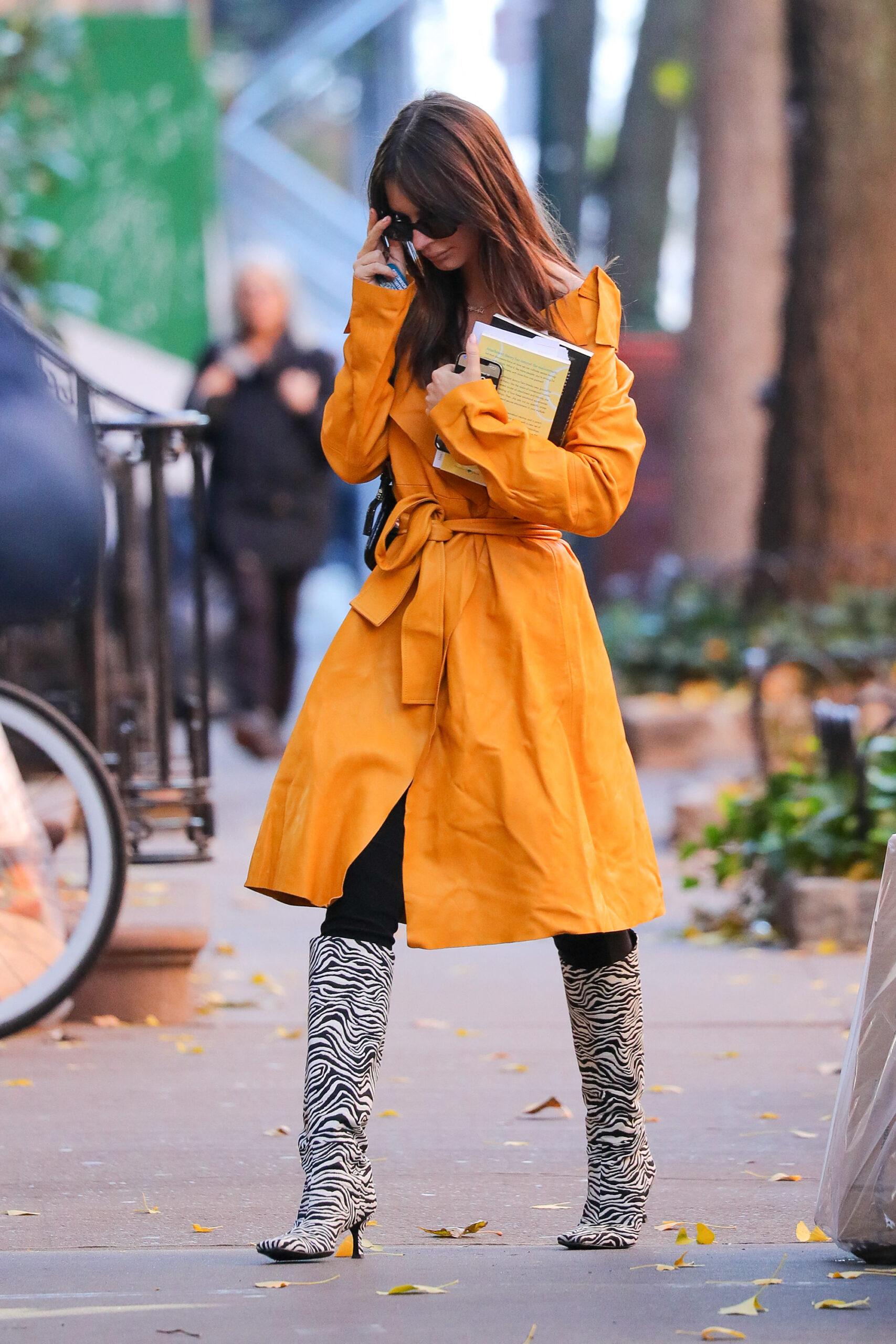 Emily Ratajkowski wears a yellow coat while out and about in New York City