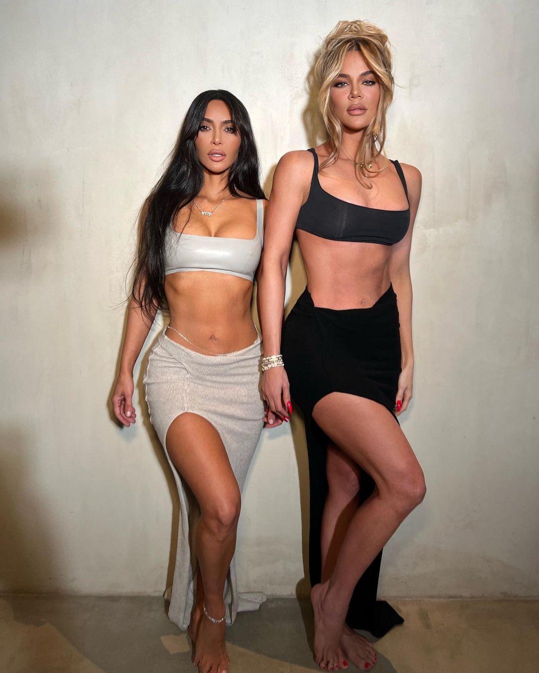 Kim and Khloe Kardashian rock matching outfits with matching abs