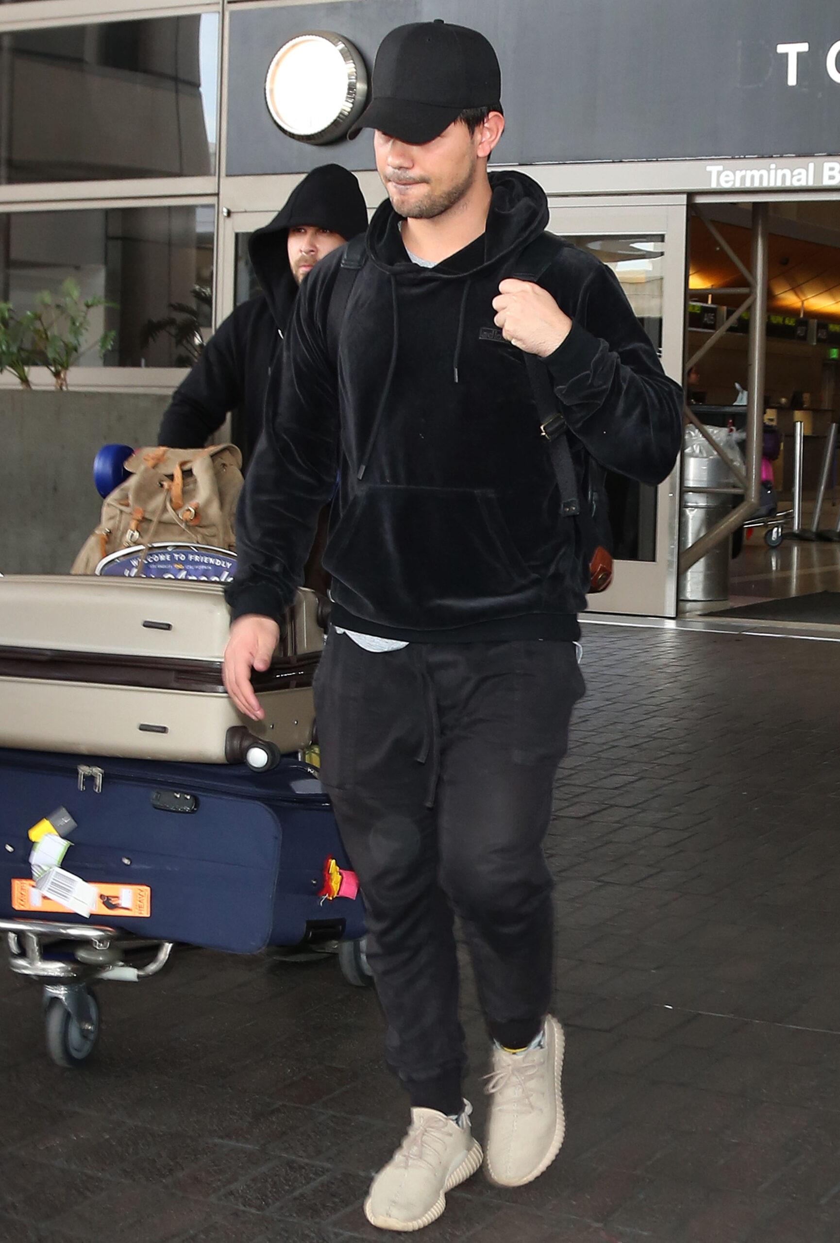 Taylor Lautner arriving at the Los Angeles International Airport
