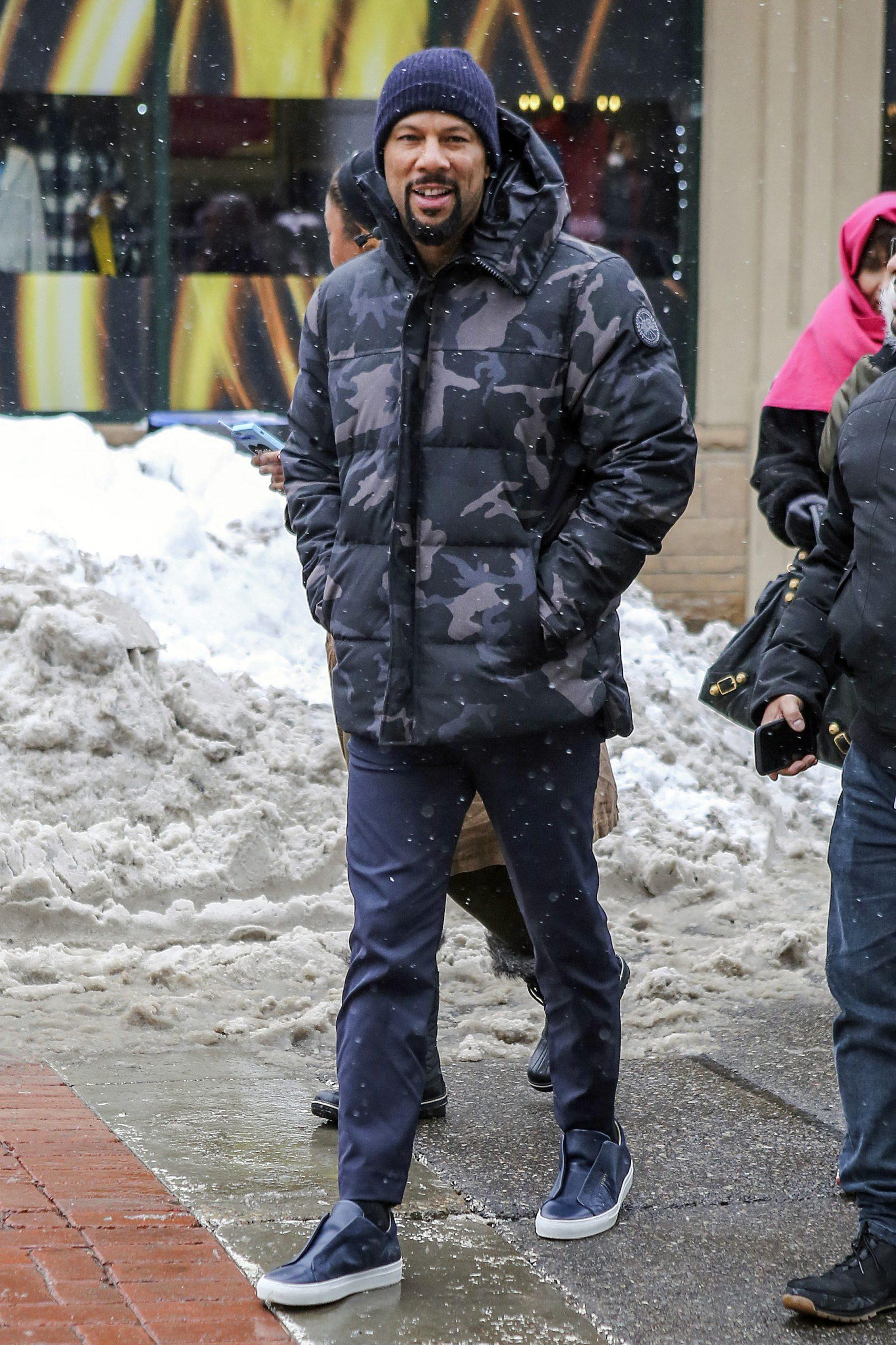 Common cozies up with a military parka whilst promoting 'Burning Sands' at Sundance!