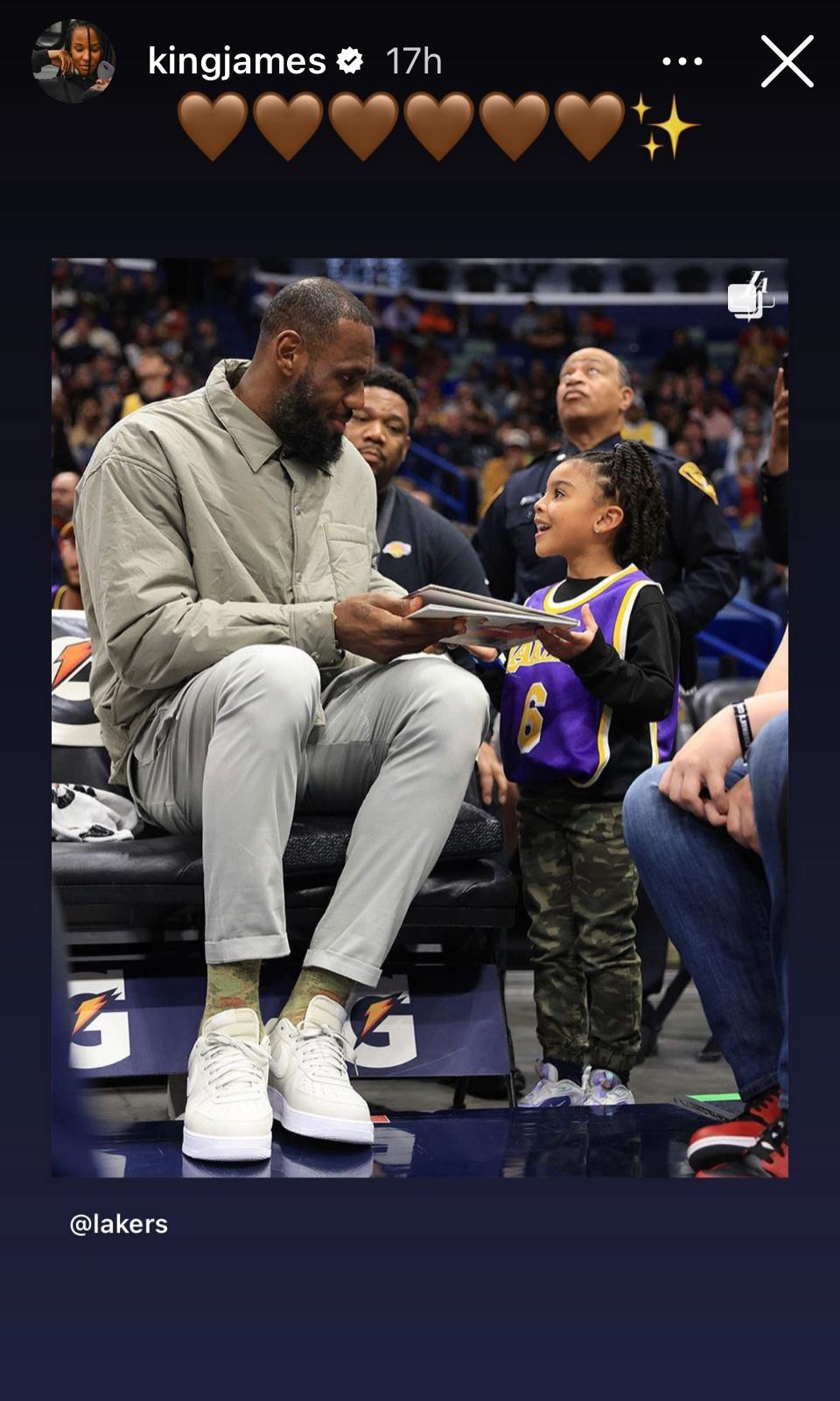 LeBron James signs book for young fan
