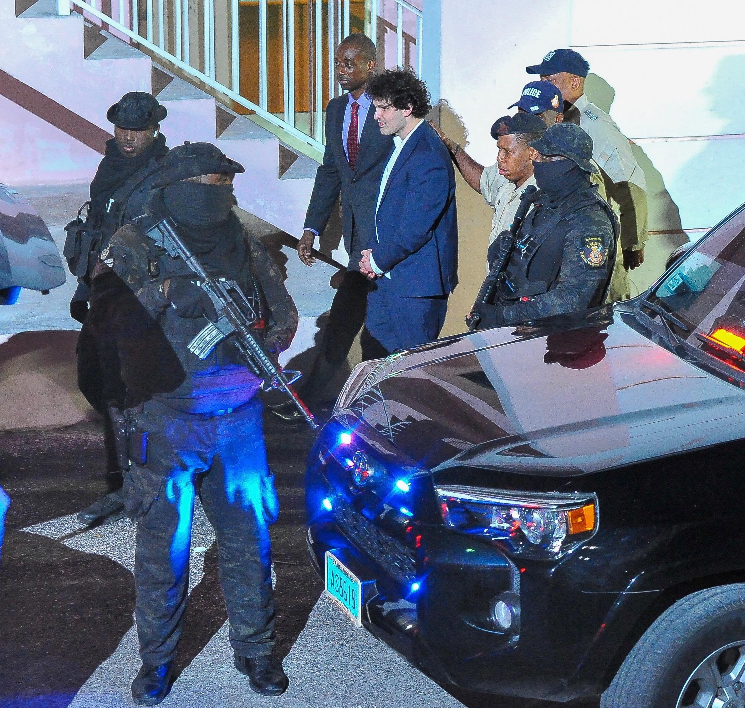FTX founder Sam Bankman-Fried is seen in handcuffs as he leaves a court in the Bahamas after U S files criminal charges