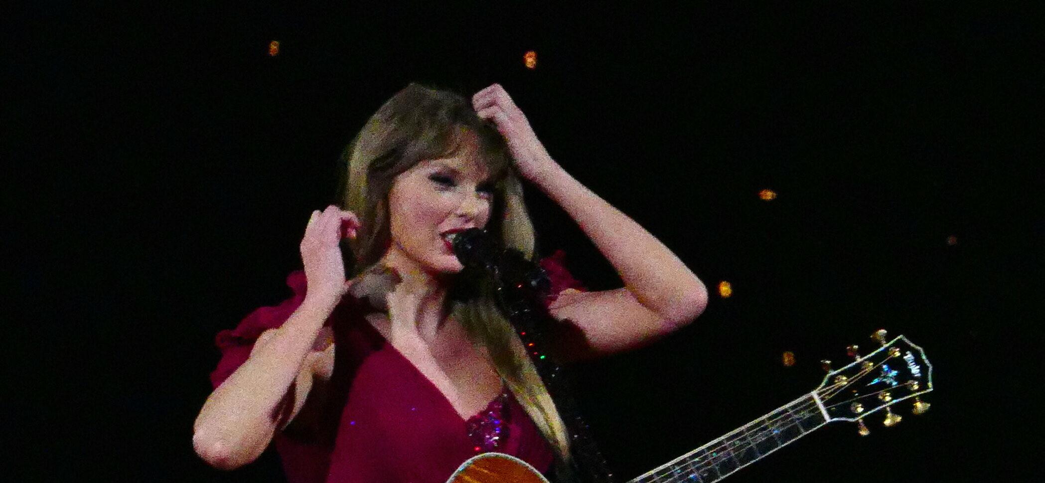 Taylor Swift has to fix her dress sleeve on opening night as her wardrobe falls apart during multimilion dollar tour in Arizona