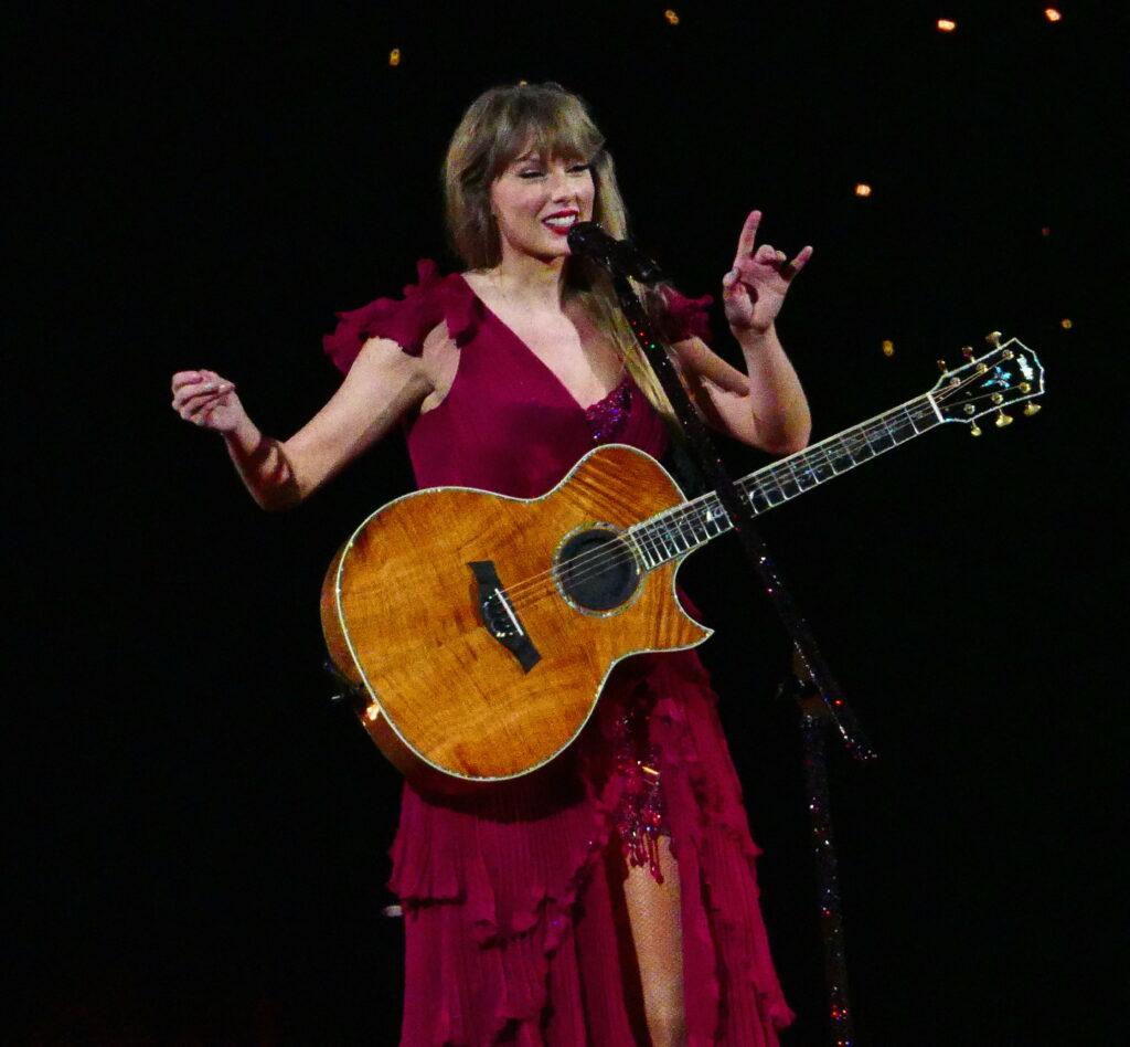 Taylor Swift has to fix her dress sleeve on opening night as her wardrobe falls apart during multimilion dollar tour in Arizona
