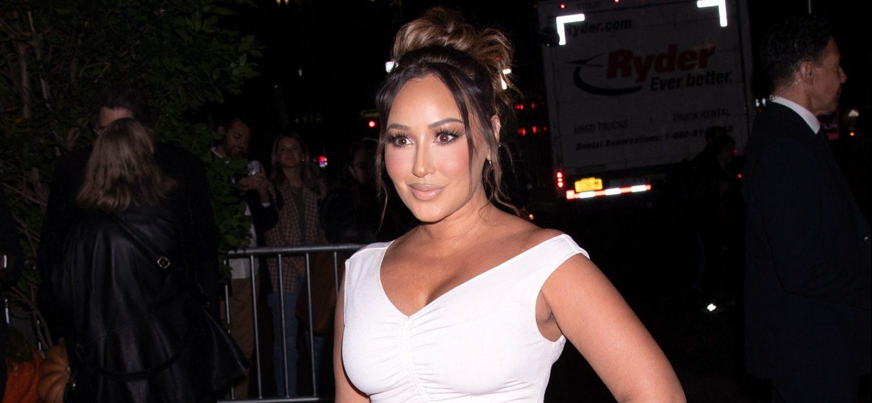 Adrienne Bailon Gets Hearts Racing In Curve-Hugging Skimpy Black Dress At NYFW