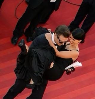 Alec Baldwin carrying Hilaria Baldwin up the steps at Cannes