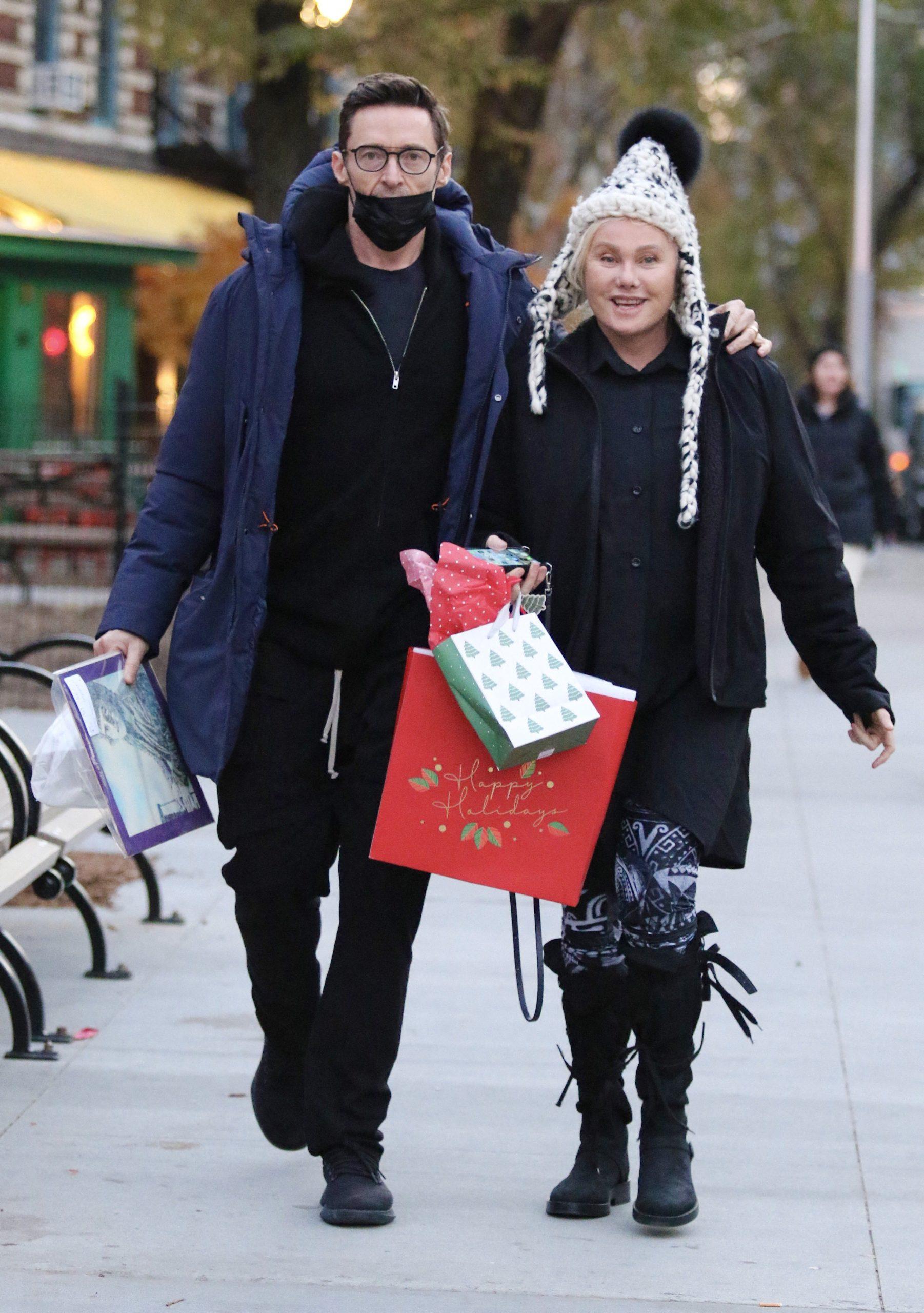 Hugh Jackman and wife Deborra-Lee Furness carry early Christmas presents and a copy of Elton Johns EMPTY SKY debut studio album after having a late lunch in NYC