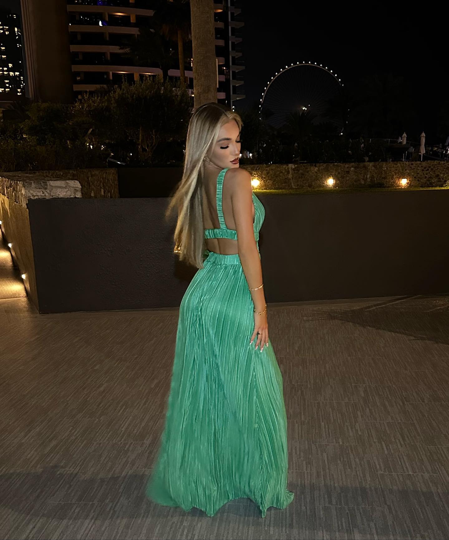 Beaux Raymond poses in a green gown