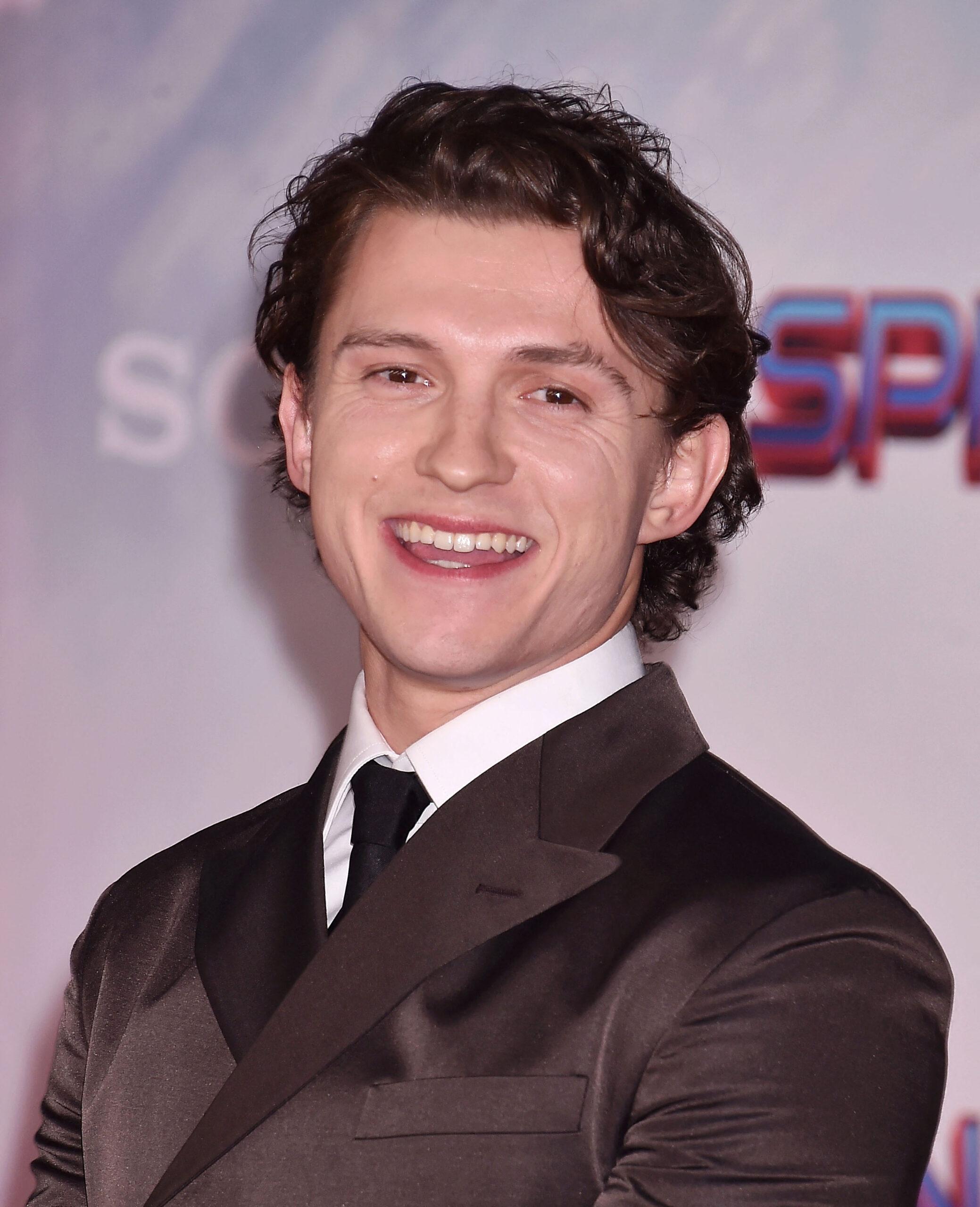 Tom Holland nearly bopped himself waving the chequered flag