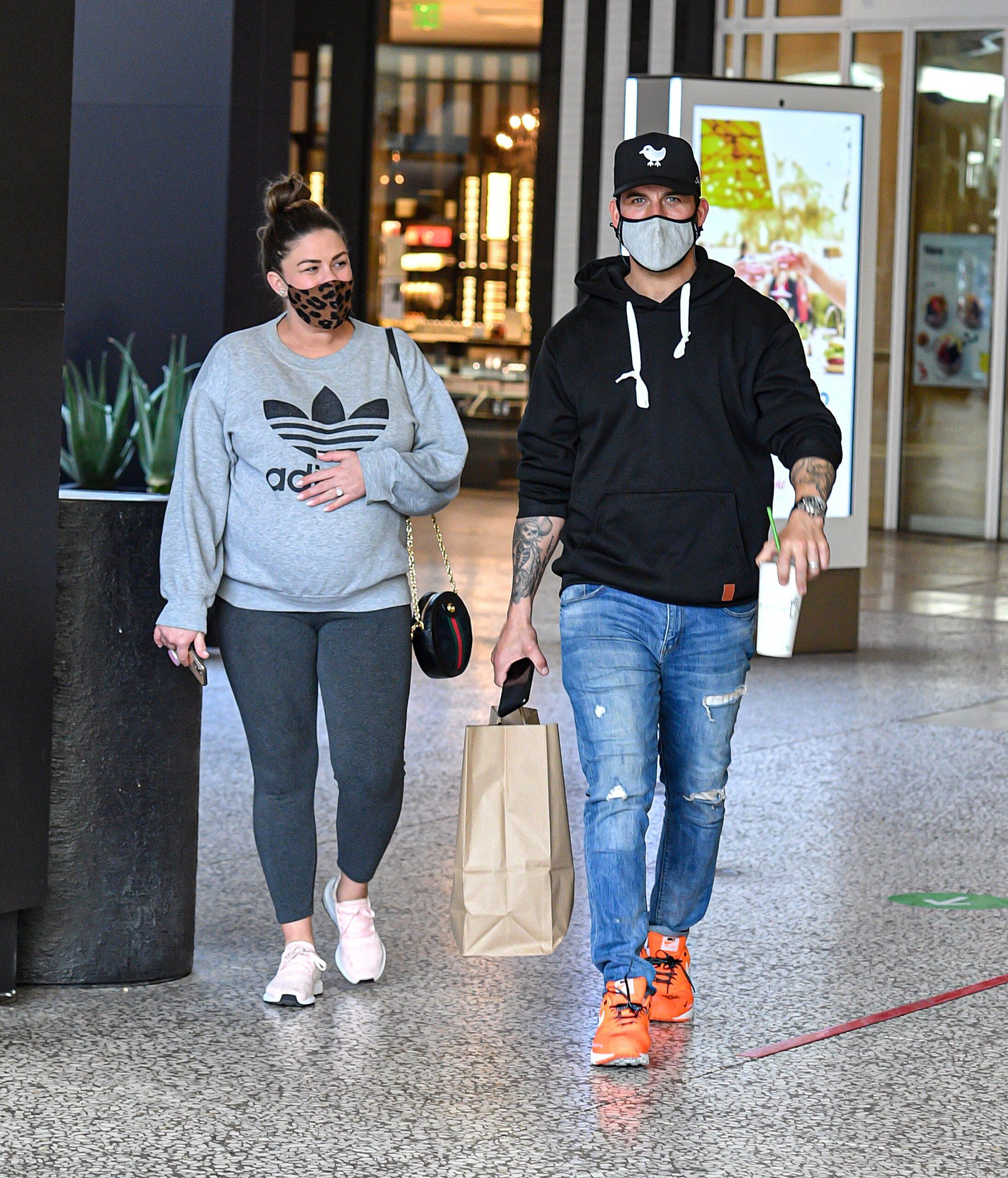 Brittany Cartwright is spotted holding onto her growing baby bump while shopping at the Century City Westfield Center with husband Jax Taylor in Los Angeles CA