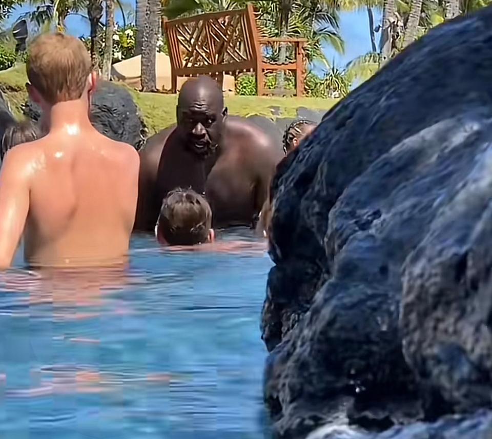 Shaq in a pool with a bunch of kids