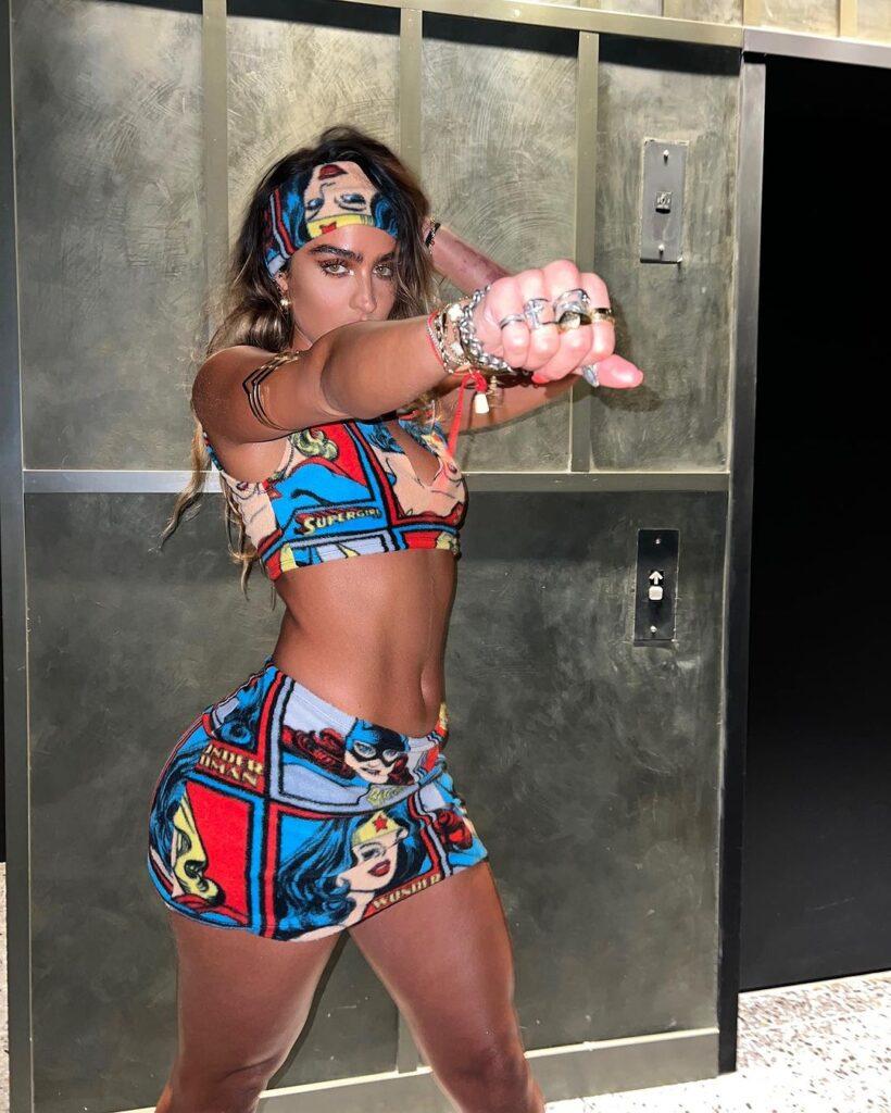 Sommer Ray wears a tiny crop top and skirt with a Wonder Woman print.