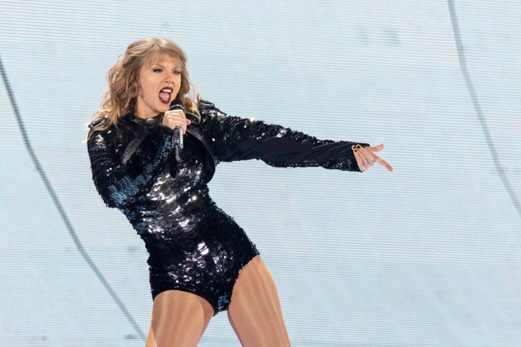 Taylor Swift performing behind "Reputation"