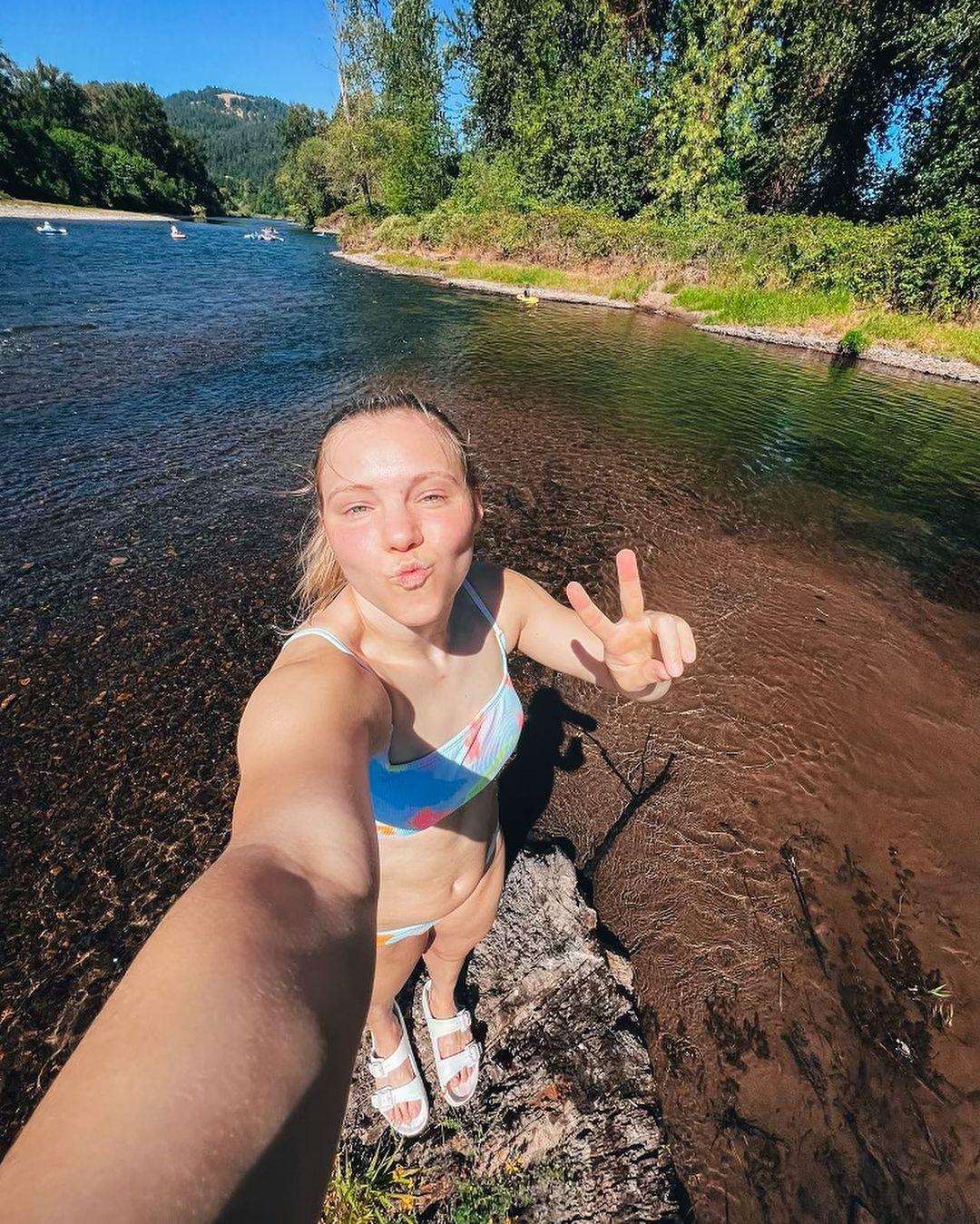 Jade Carey flashing a peace sign while wearing a bikini.