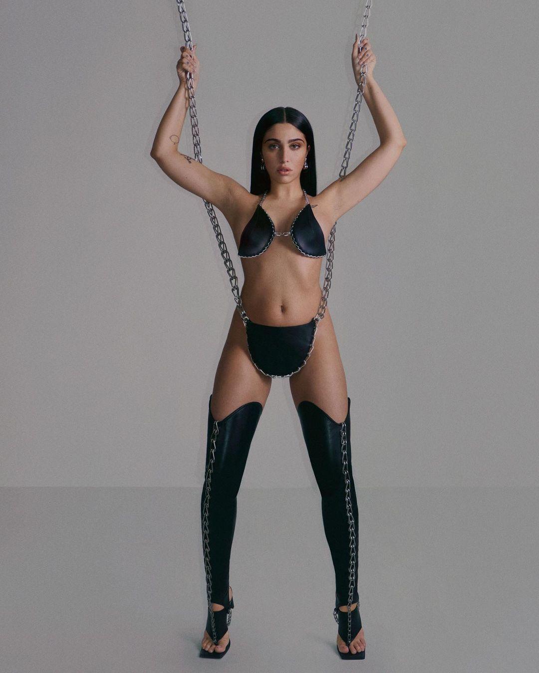 Lourdes Leon wearing nothing but black leather bags.