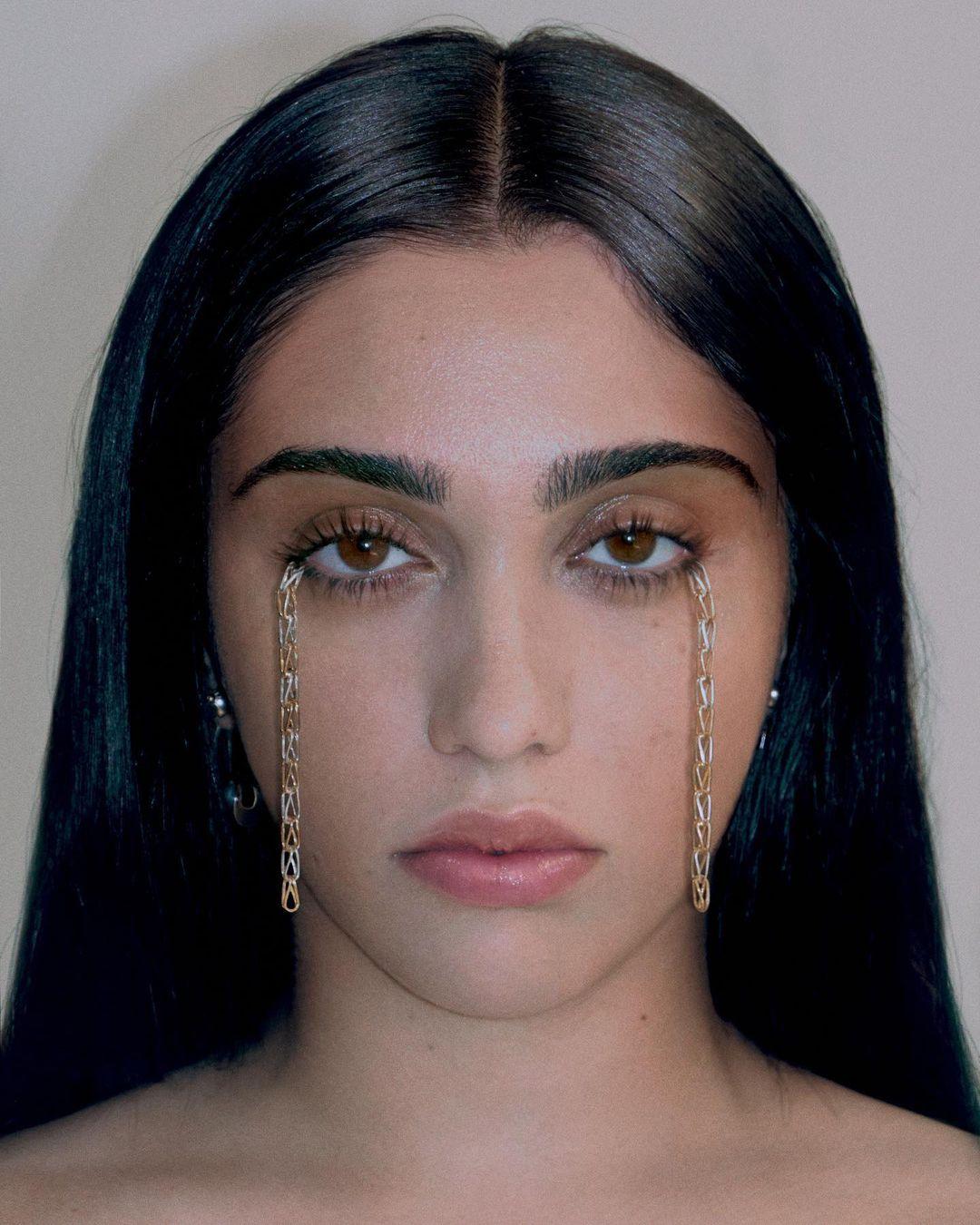 A portrait shot of Lourdes Leon with chains attached to her lashes.