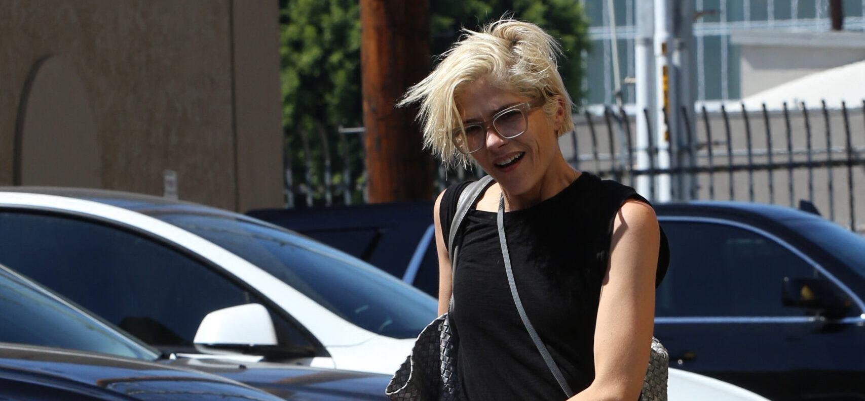 Selma Blair walks her dog before heading out in a limo for a trip