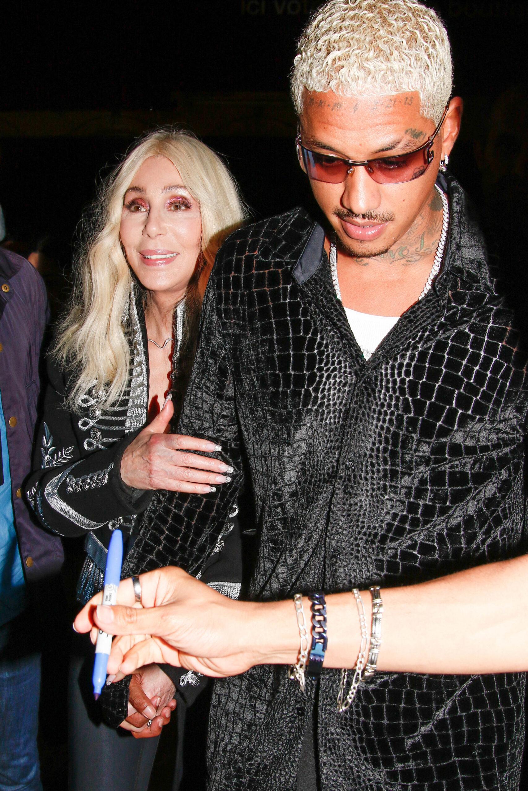 Cher and beau Alexander Edwards arriving at Costes restaurant during Paris Fashion Week