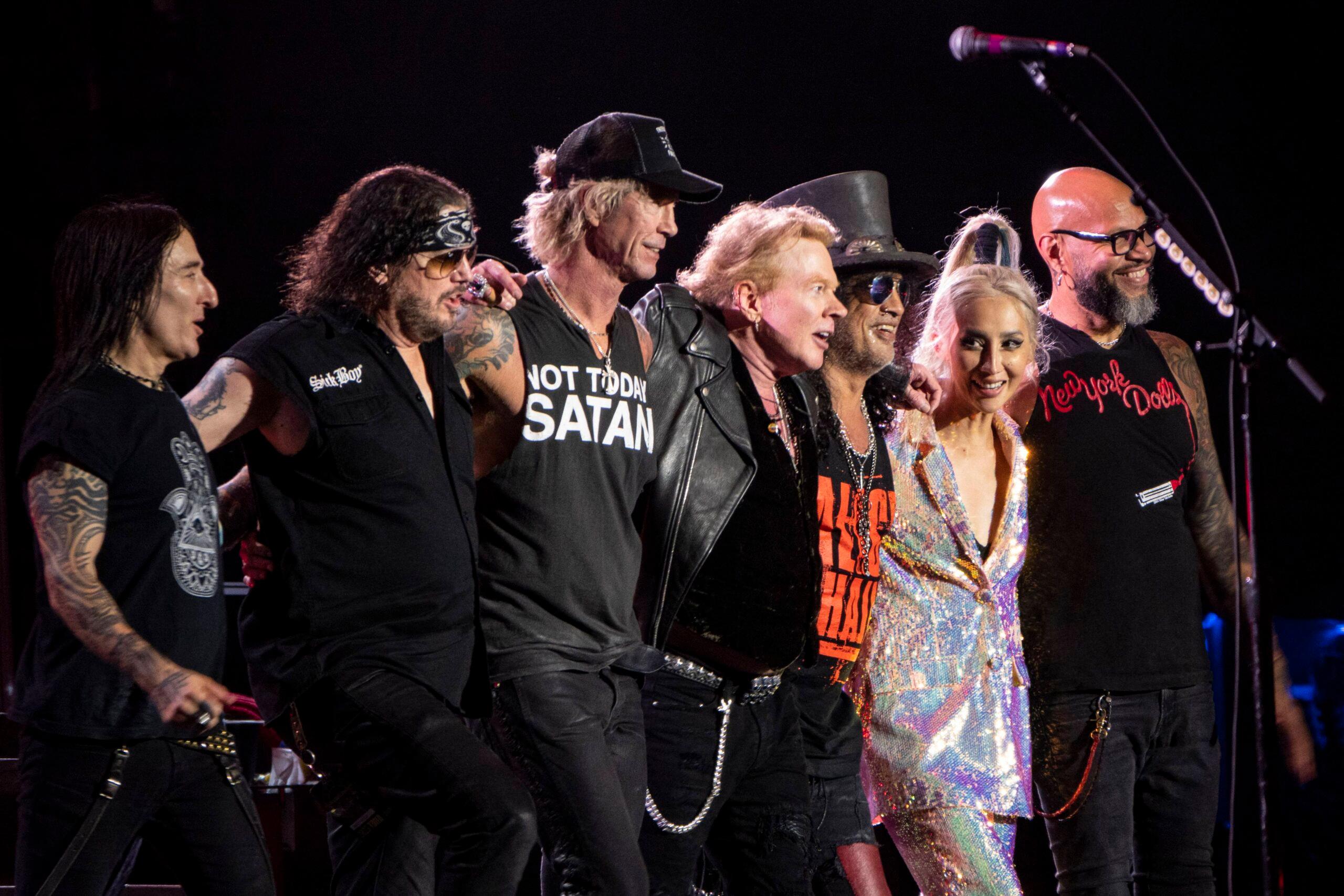 Duff McKagan, left, Axl Rose, and Slash of the rock band Guns N' Roses perform live onstage at Snapdragon Stadium in San Diego