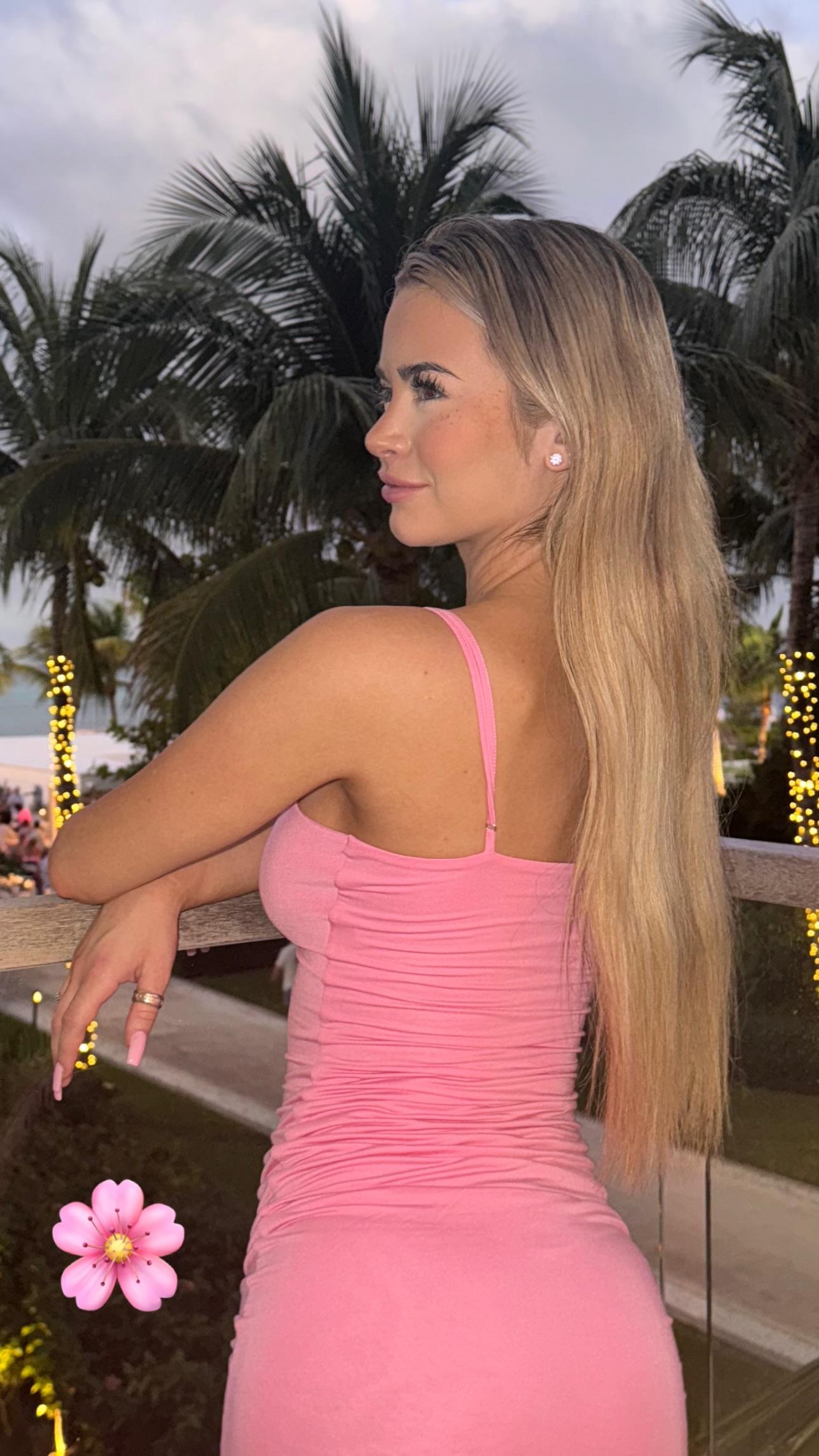 Emily Elizabeth poses for the camera in her pink dress.