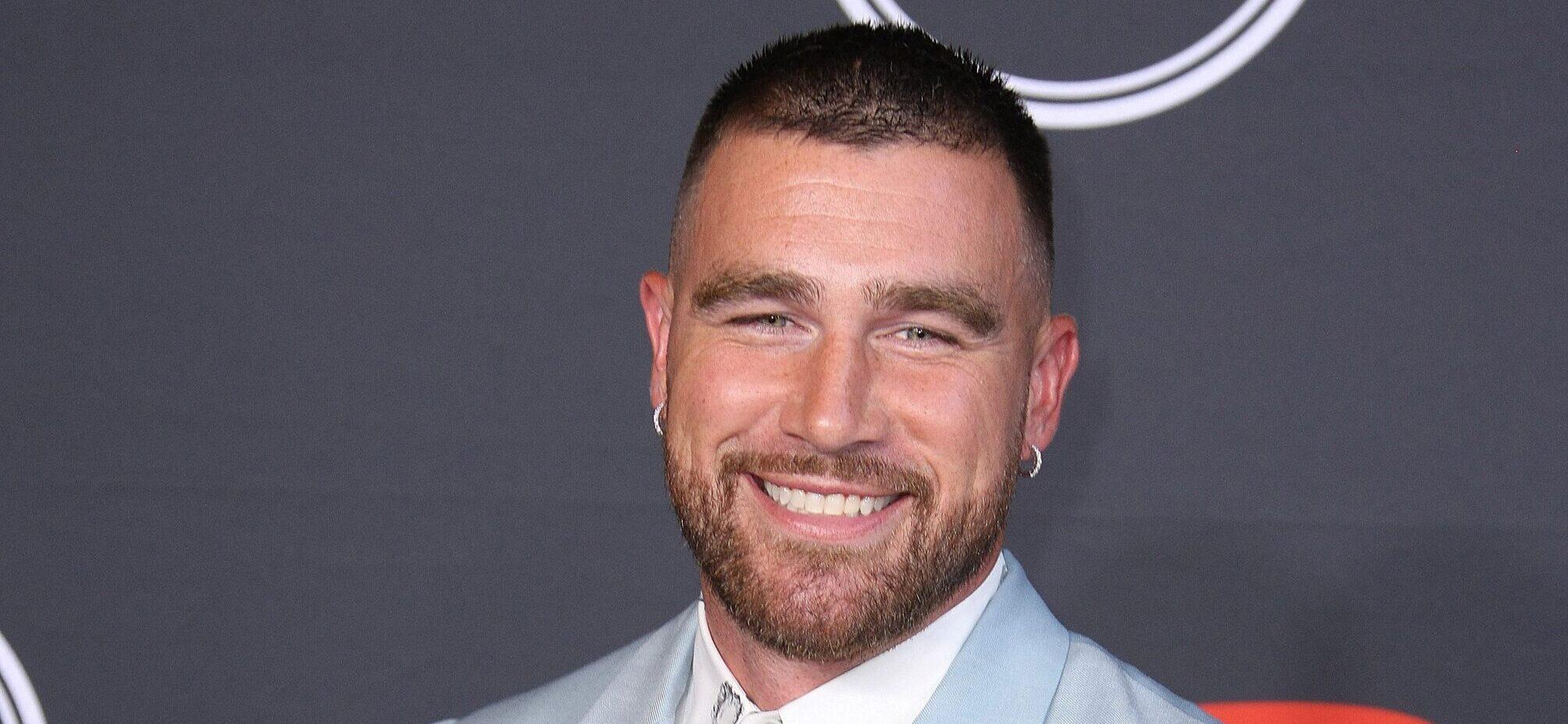 Travis Kelce smiling on the red carpet