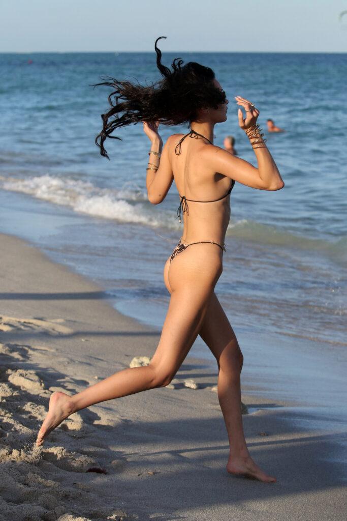 Bella Hadid wears a tiny leopard print string bikini as she goes for a dip in the ocean in Miami. She was escorted to the beach by her seldom photographed boyfriend Marc Kalman. 13 Nov 2021 Pictured: Bella Hadid. Photo credit: MEGA TheMegaAgency.com +1 888 505 6342 (Mega Agency TagID: MEGA805115_002.jpg) [Photo via Mega Agency]