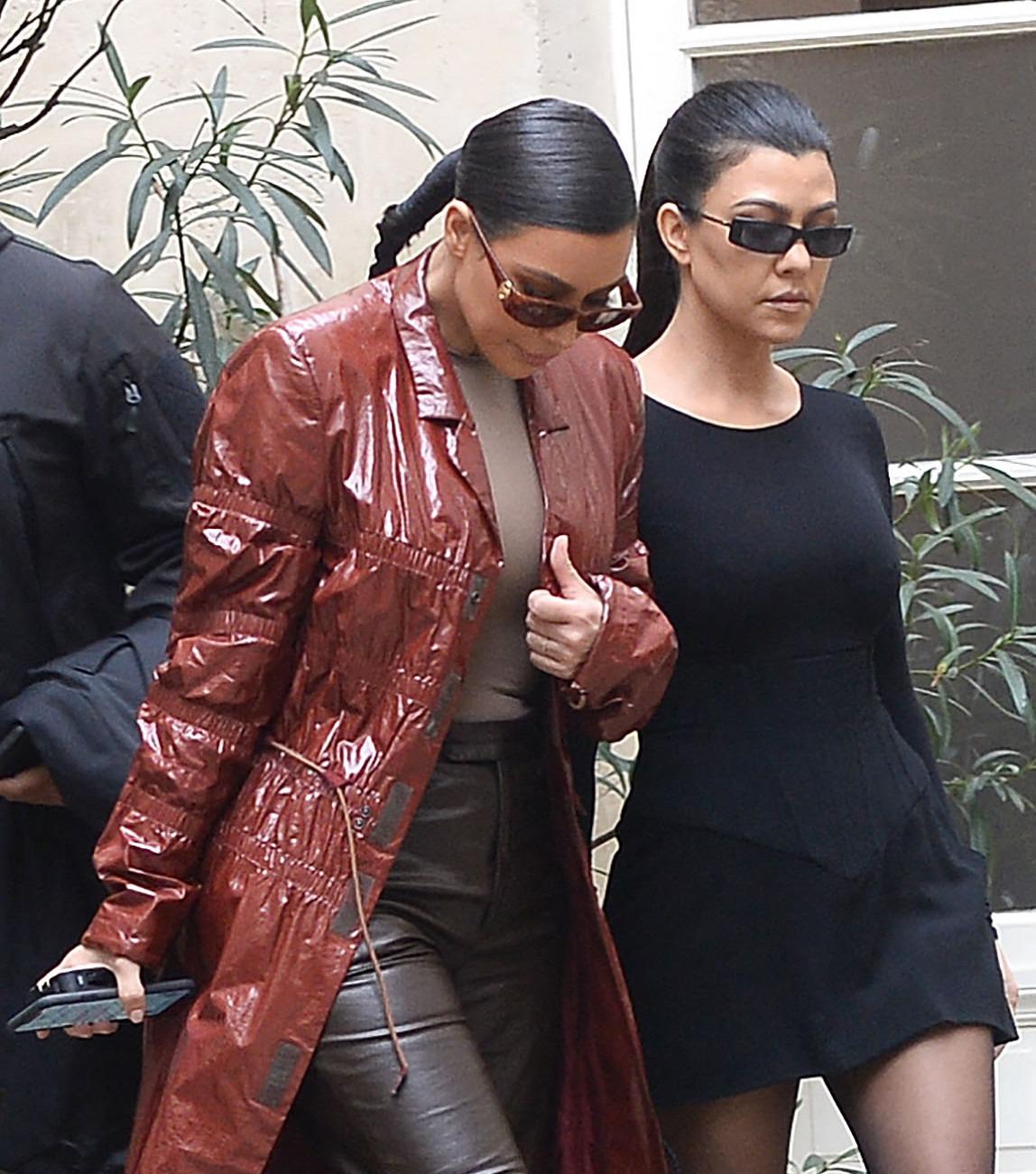 Kim Kardashian and sister Kourtney Kardashian arrive at Le Flore Cafe in Paris