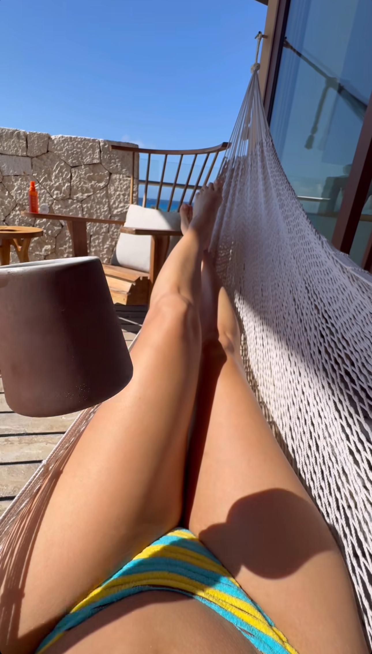 Eva Longoria on a hammock enjoying her coffee.