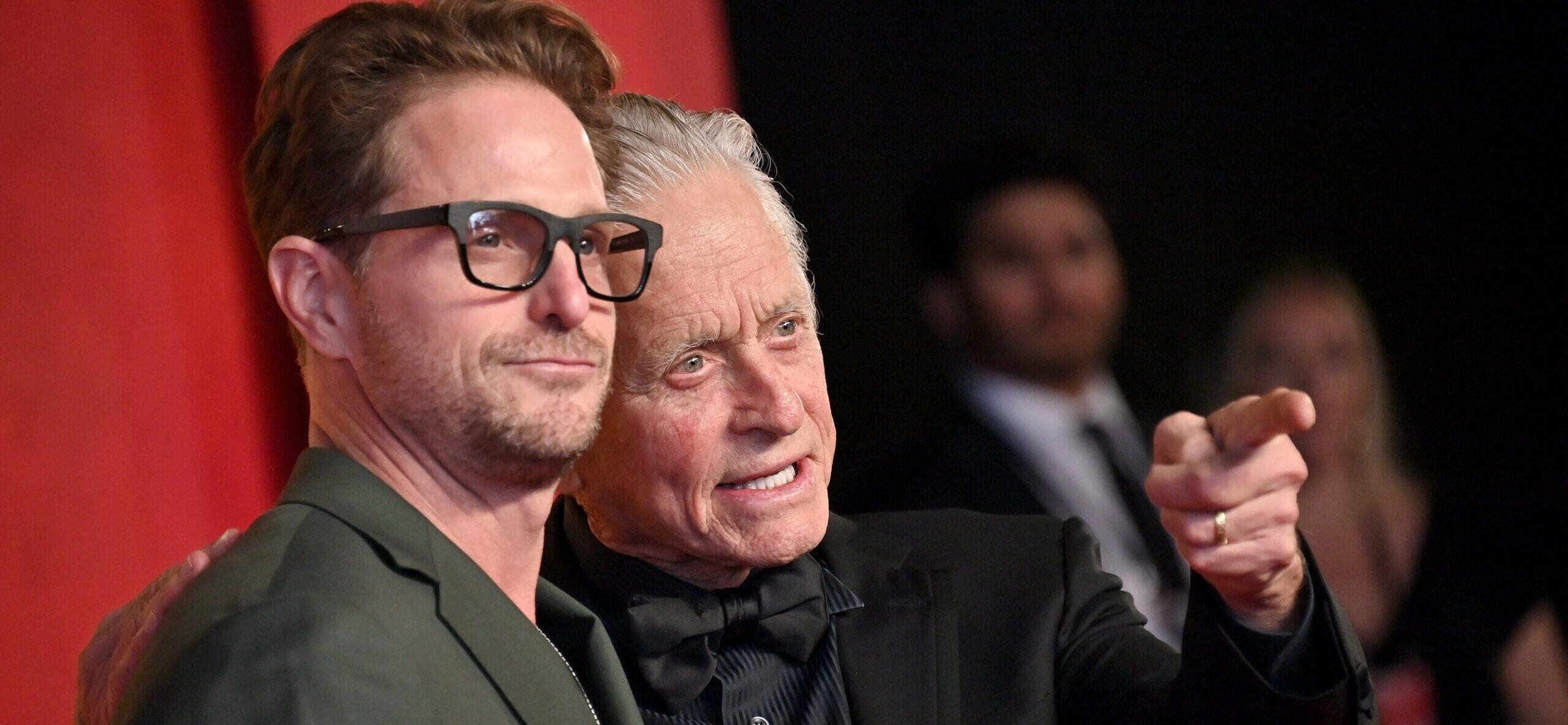 Michael Douglas and son Cameron pose on red carpet.