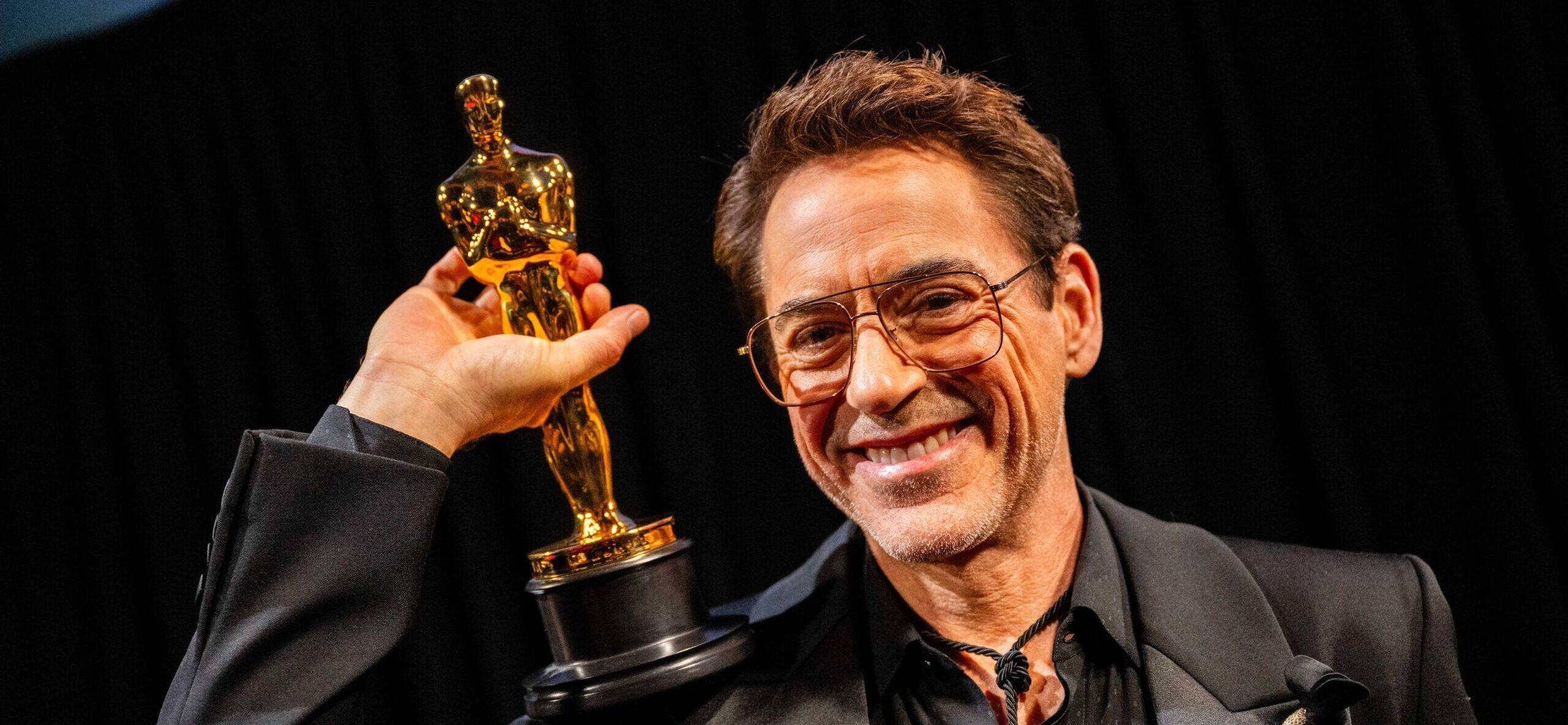 Robert Downey Jr. holding his Oscar trophy