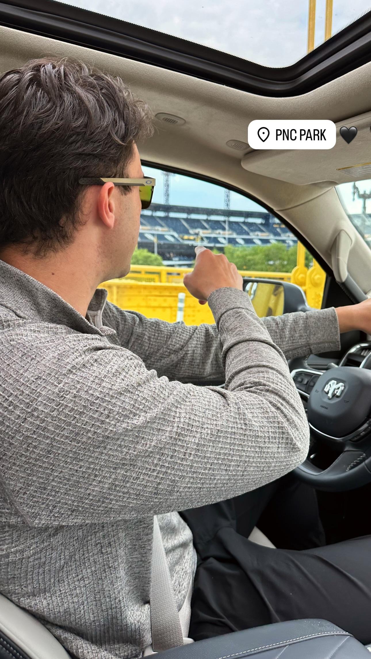 Olivia Dunne takes a photo of Paul Skenes in the car.