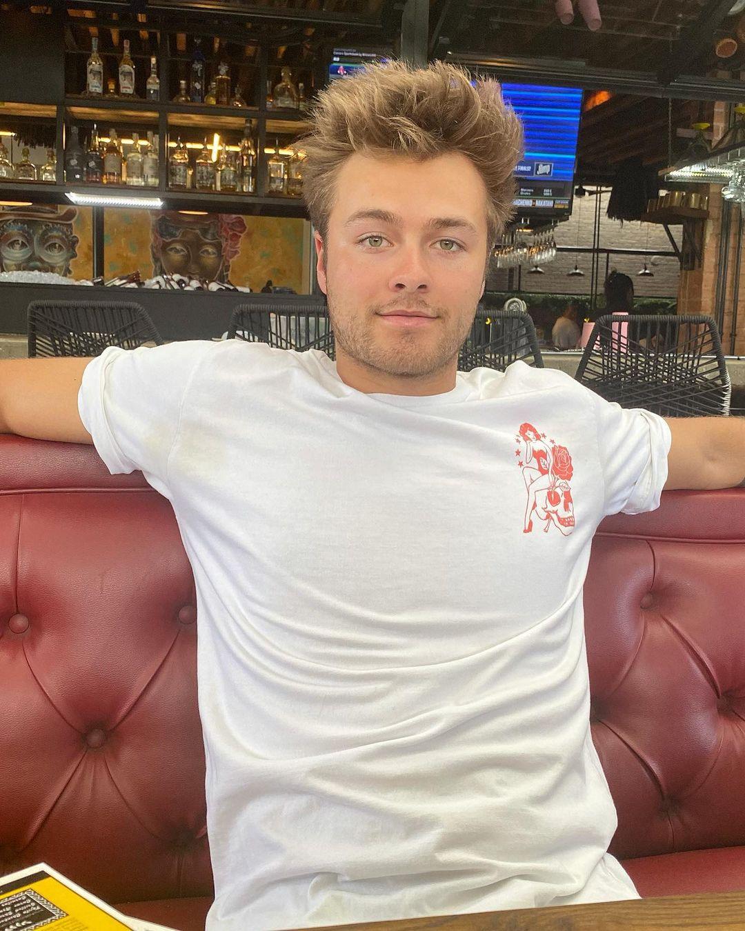 Peyton Meyer sitting on a couch