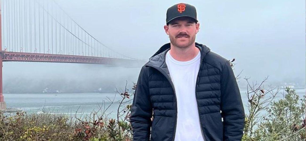 Grayson Murray posing in front of a bridge