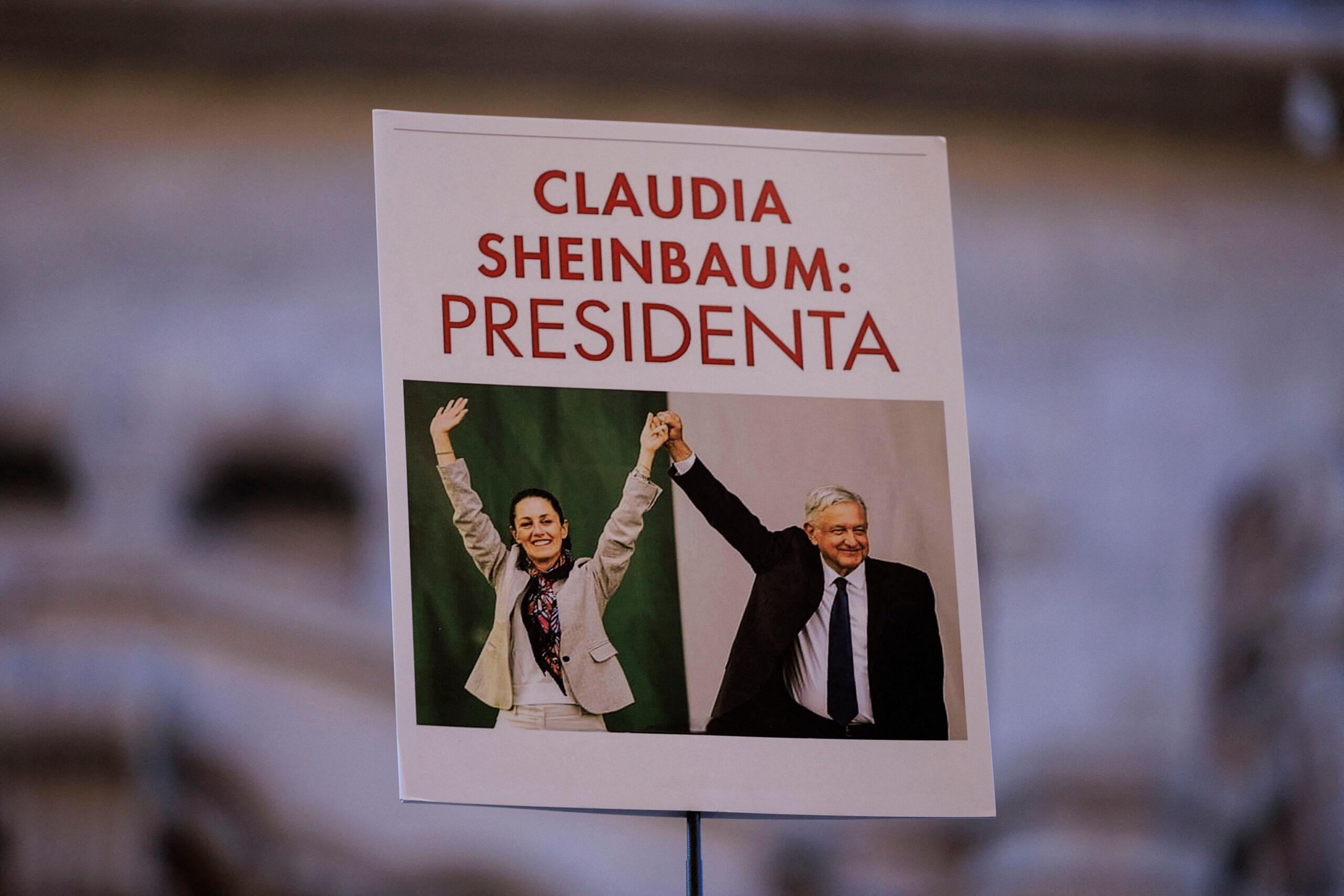 Supporter holds up a poster where current president Manuel Lopez Obrador holds up of Mexican presidential candidate for the party of Morena