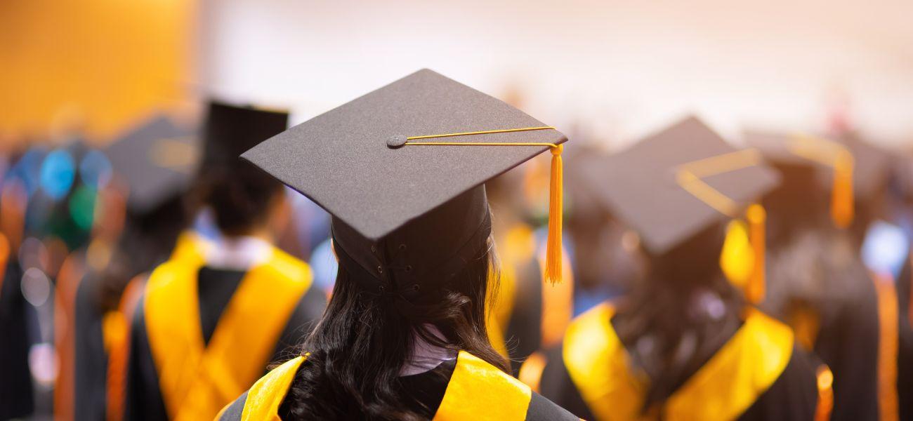 Students wearing graduation caps and gowns