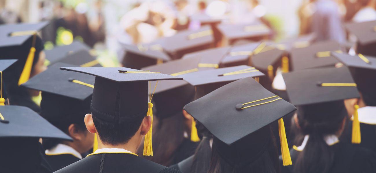 Students wearing graduation caps and gowns