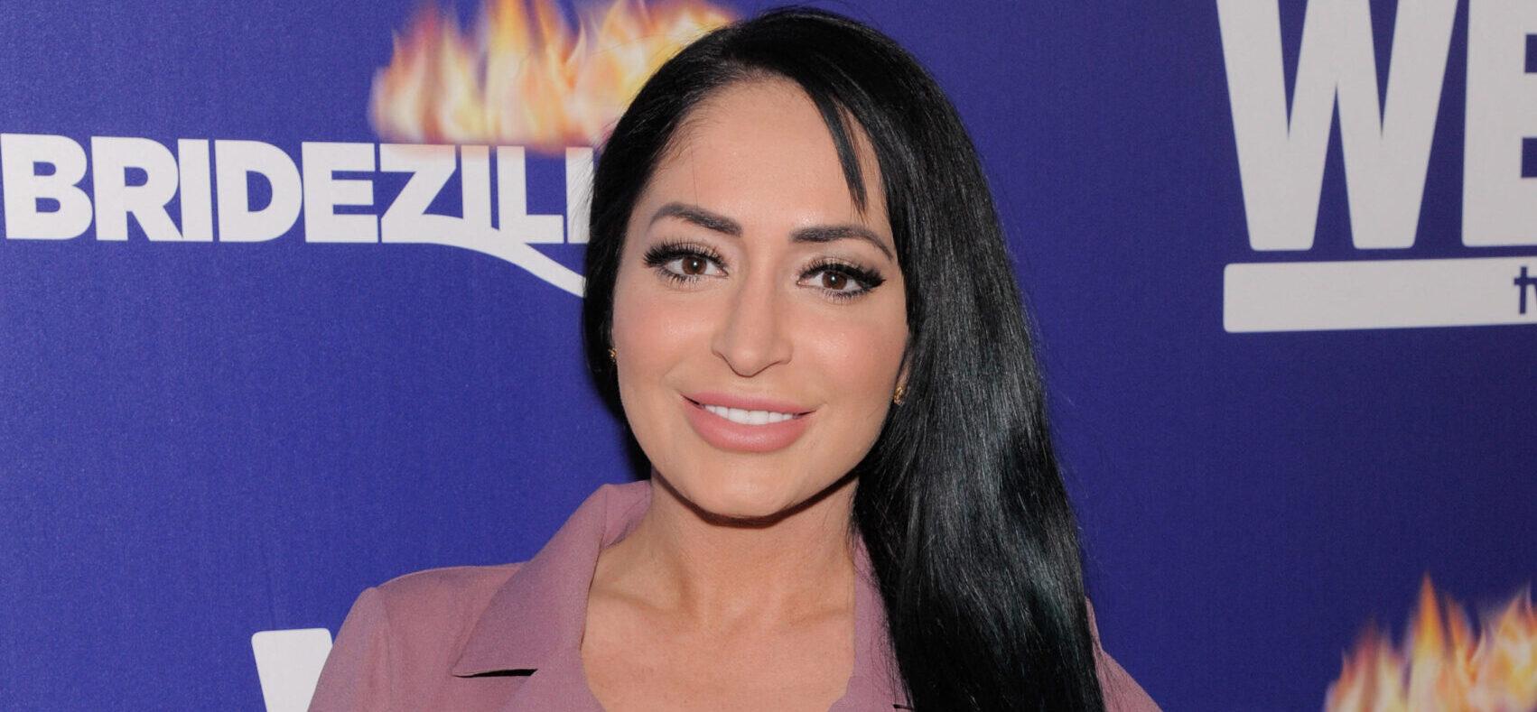 Angelina Pivarnick poses on the red carpet at WEtv's Premiere Fashion Event Celebrating the Return of Bridezillas