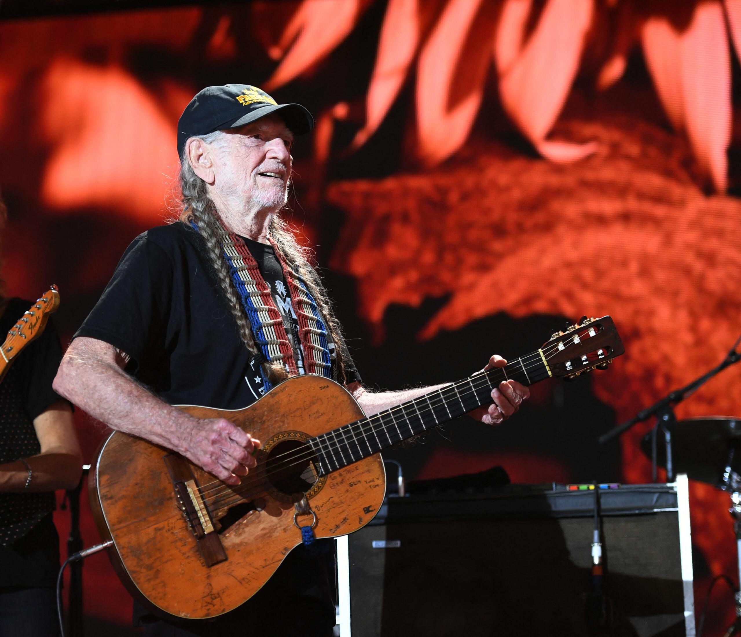 Willie Nelson playing the guitar