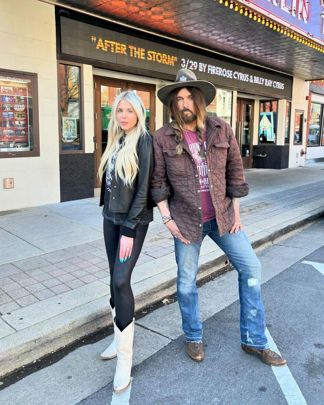 Firerose and Billy Ray Cyrus pose together outside The Franklin Theatre