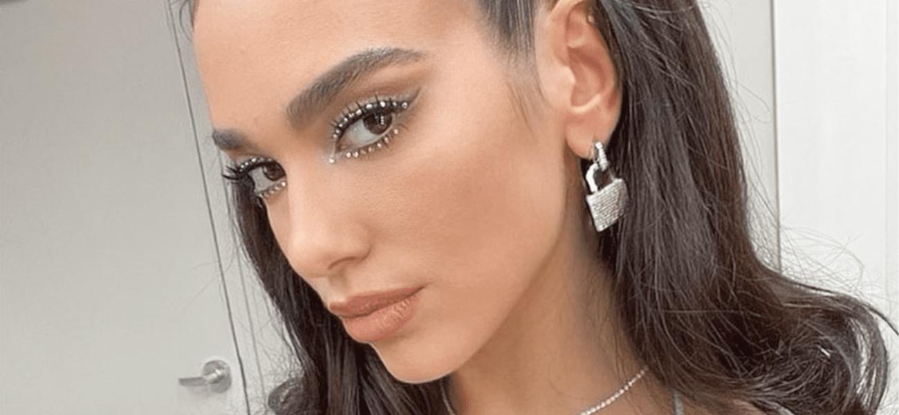 Dua Lipa poses in earrings