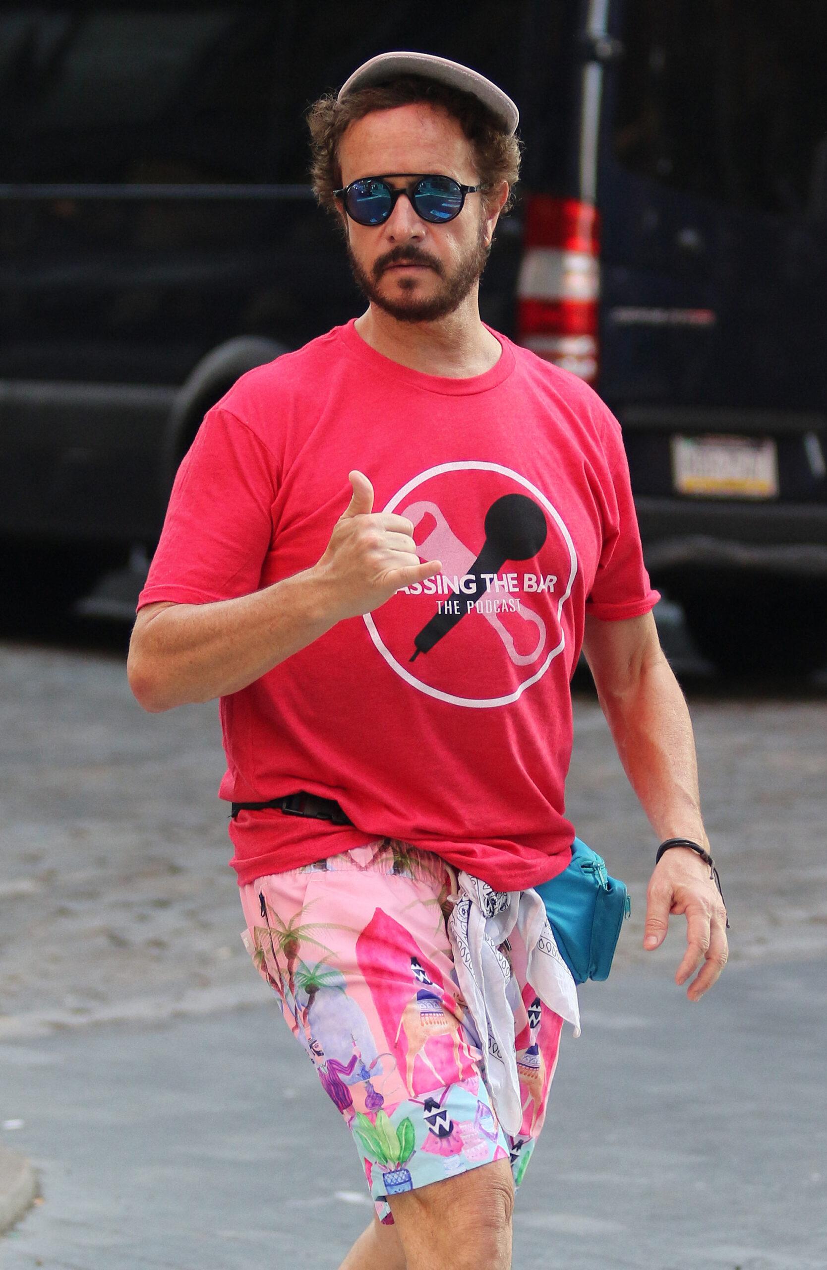 Pauly Shore sports an 80s look while browsing for T-shirts from a street vendor in New York City.