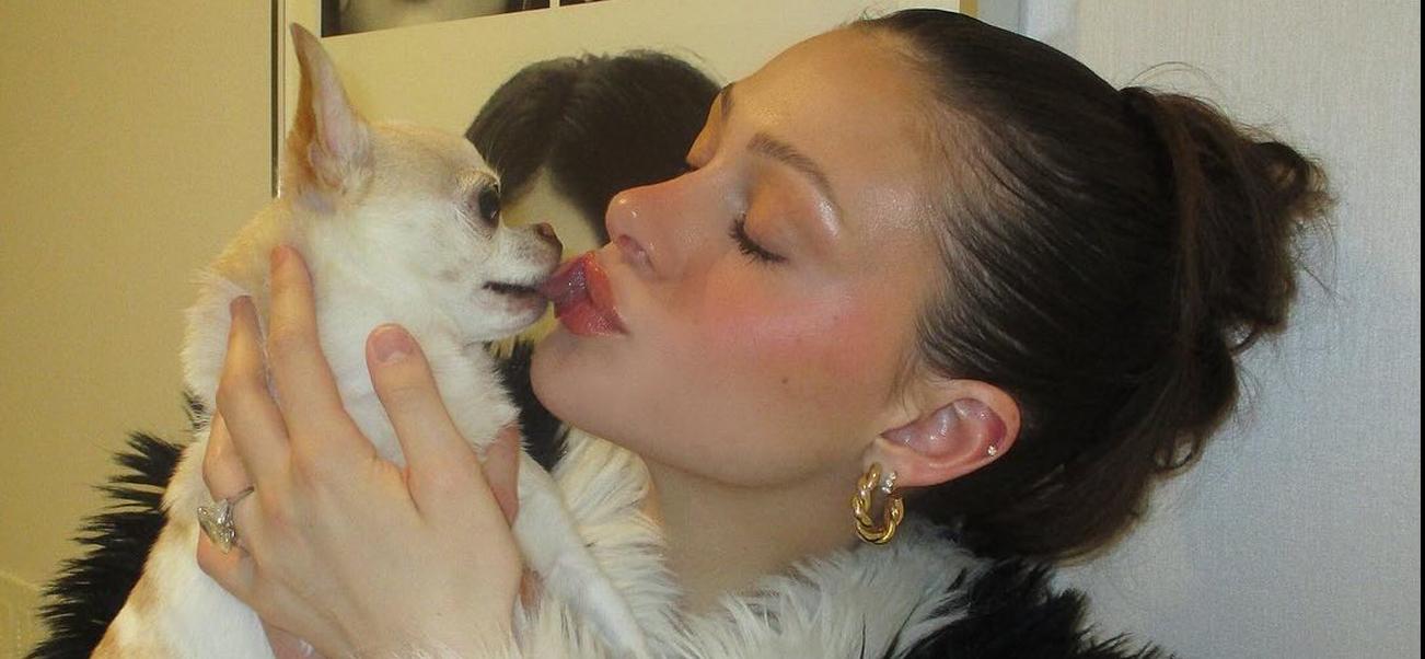 A photo of Nicola Peltz kissing her dog Nala