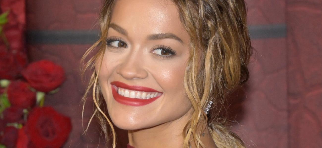 Rita Ora smiles at an event