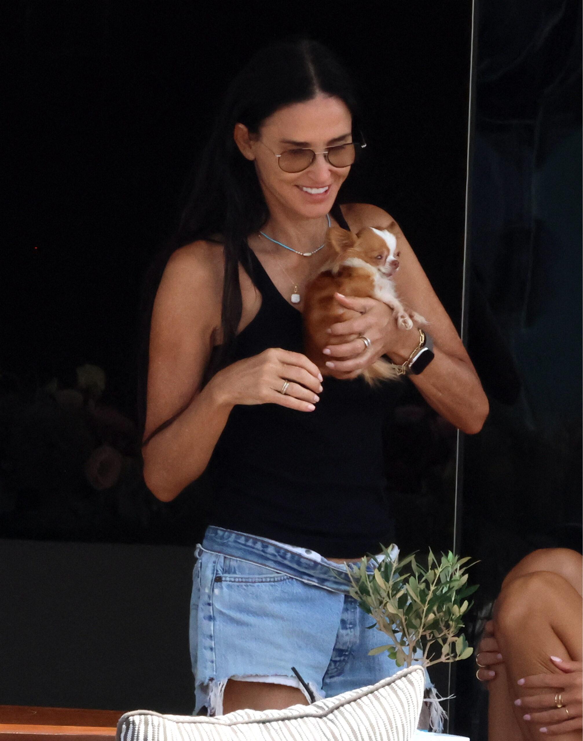 Demi Moore with her pet pup Pilaf while vacationing in Greece.