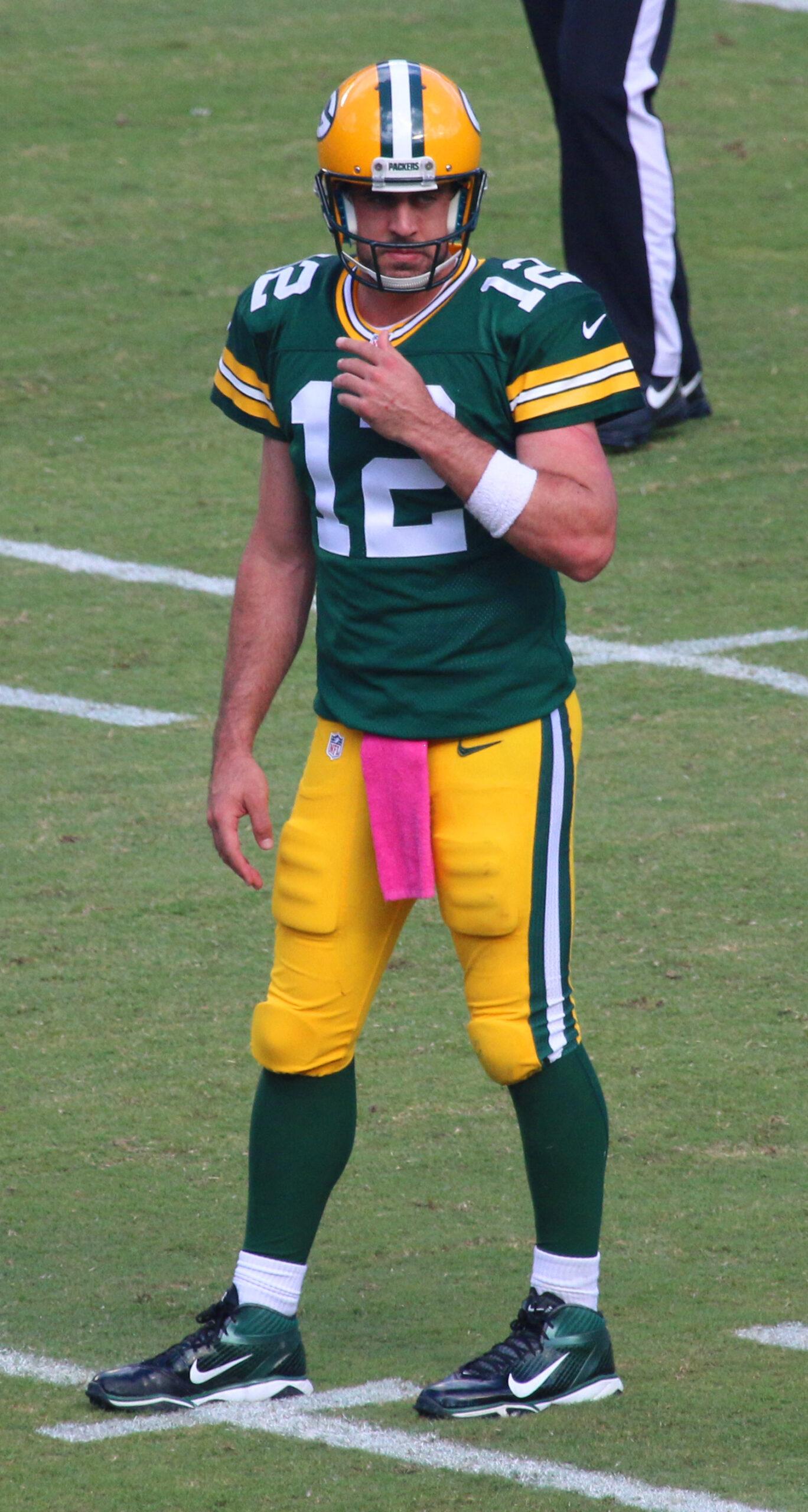 Aaron Rodgers on the football field in Miami against the Miami Dolphins