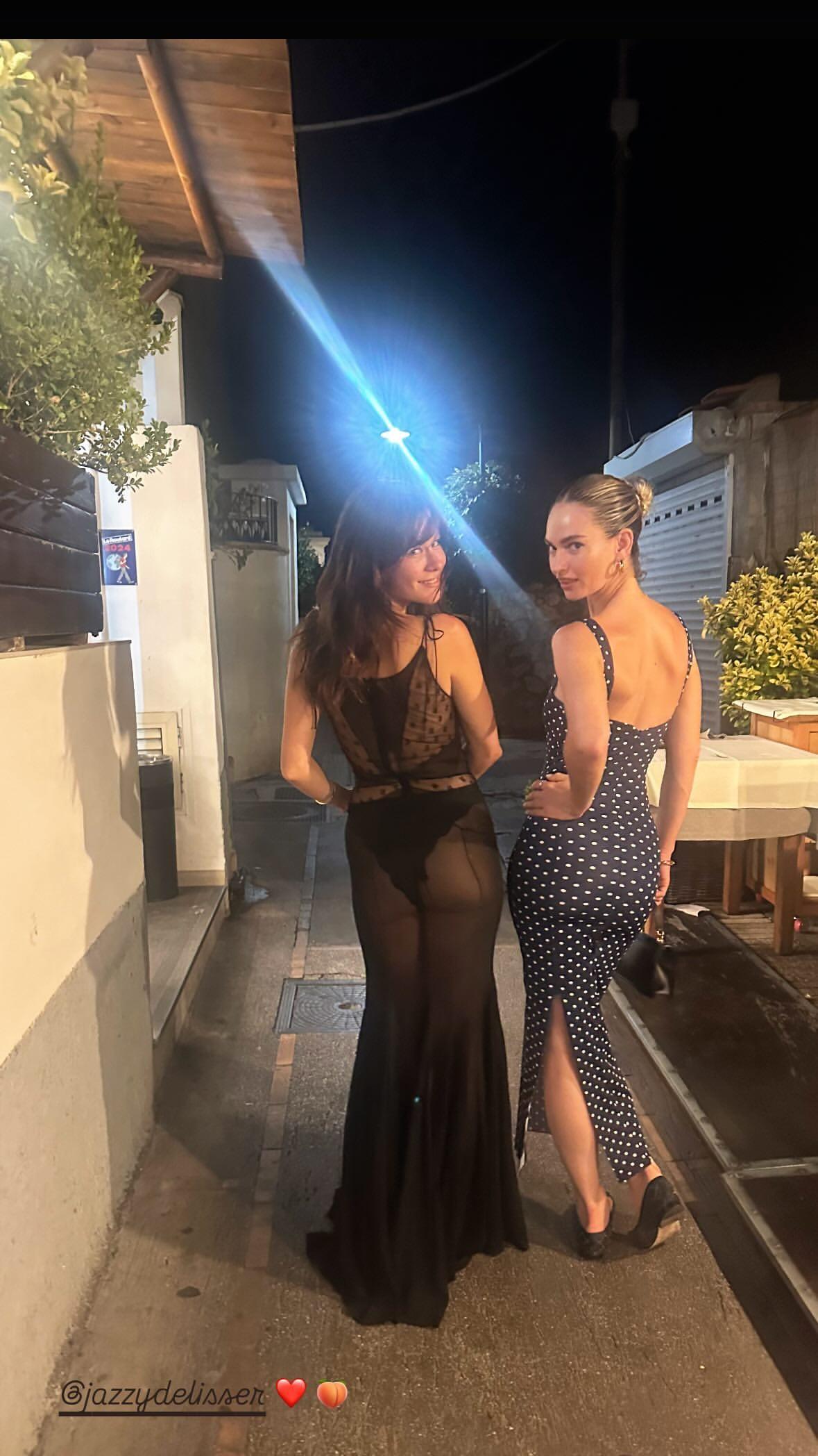 Lily James walking along the streets of Venice with a friend.